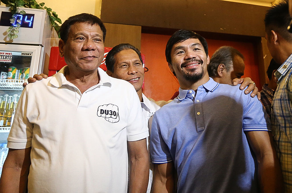 Philippines' President Rodrigo Duterte (L) stands beside boxing icon and Senator Manny Pacquiao (R) at a meeting in Davao in southern island of Mindanao on May 28, 2017. (Manman Dejeto-AFP/Getty Images)