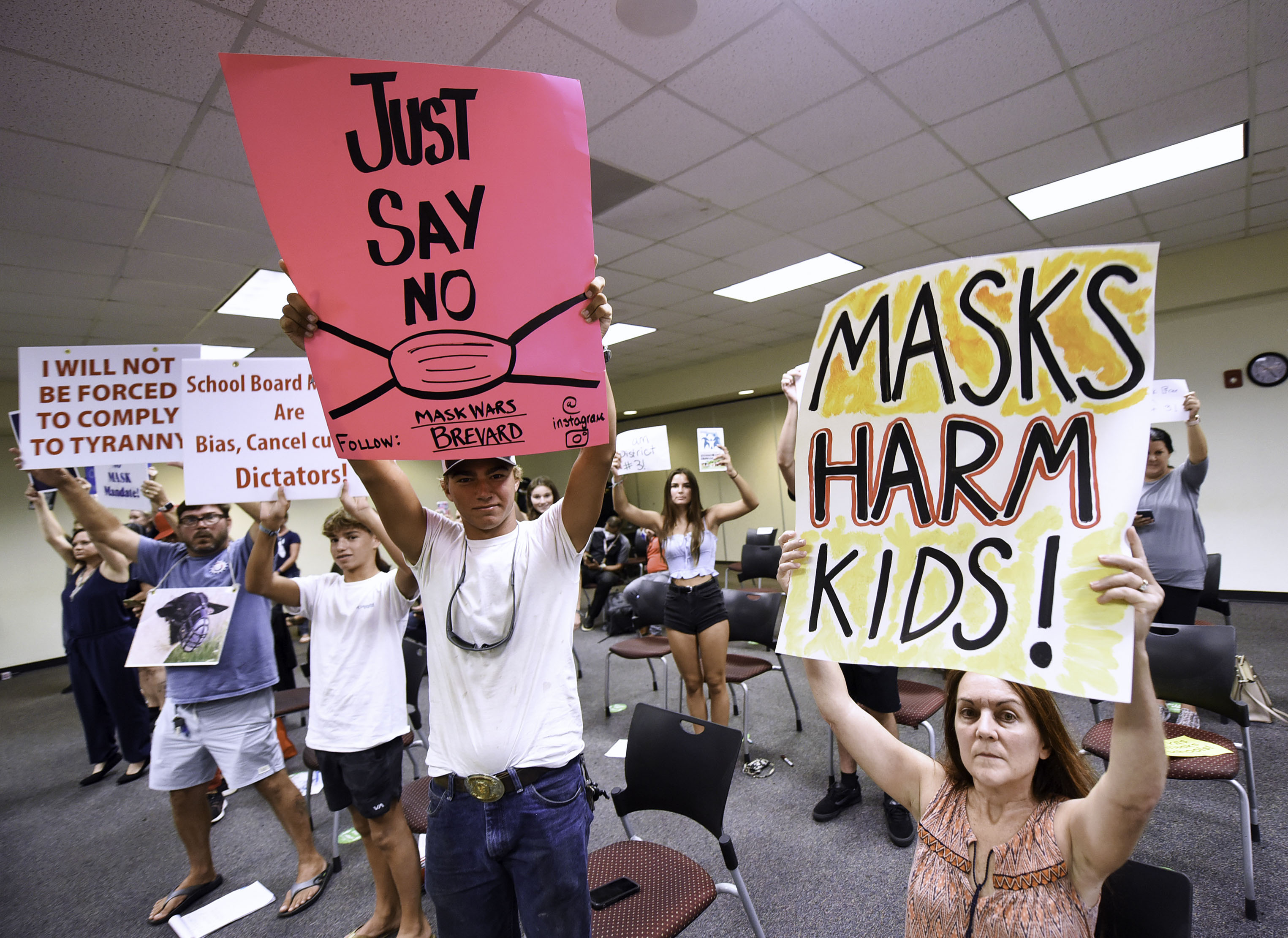 People demonstrate at a Brevard County School Board meeting in Viera, Fla., over whether face masks should be mandatory in school on Aug. 30, 2021. (Paul Hennessy—SOPA Images/Getty Images)