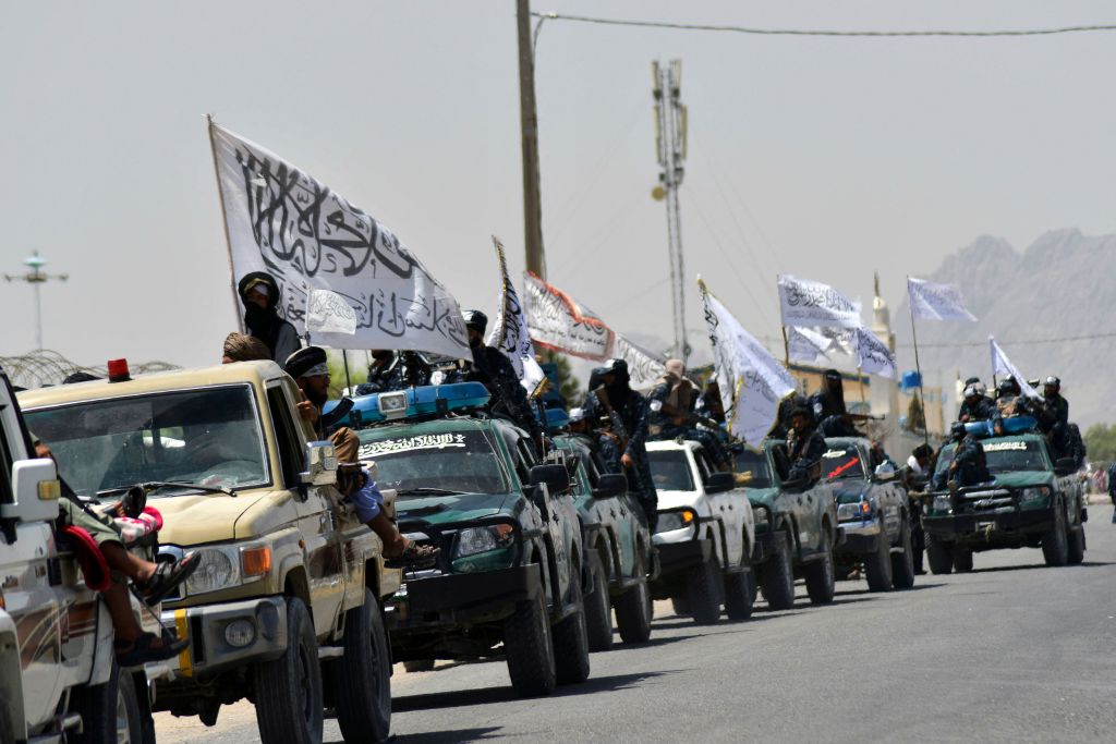 Taliban fighters atop vehicles with Taliban flags parade along a road to celebrate after the US pulled all its troops out of Afghanistan, in Kandahar on Sept. 1, 2021 following the Talibans military takeover of the country. (Javed Tanveer—AFP/Getty Images)