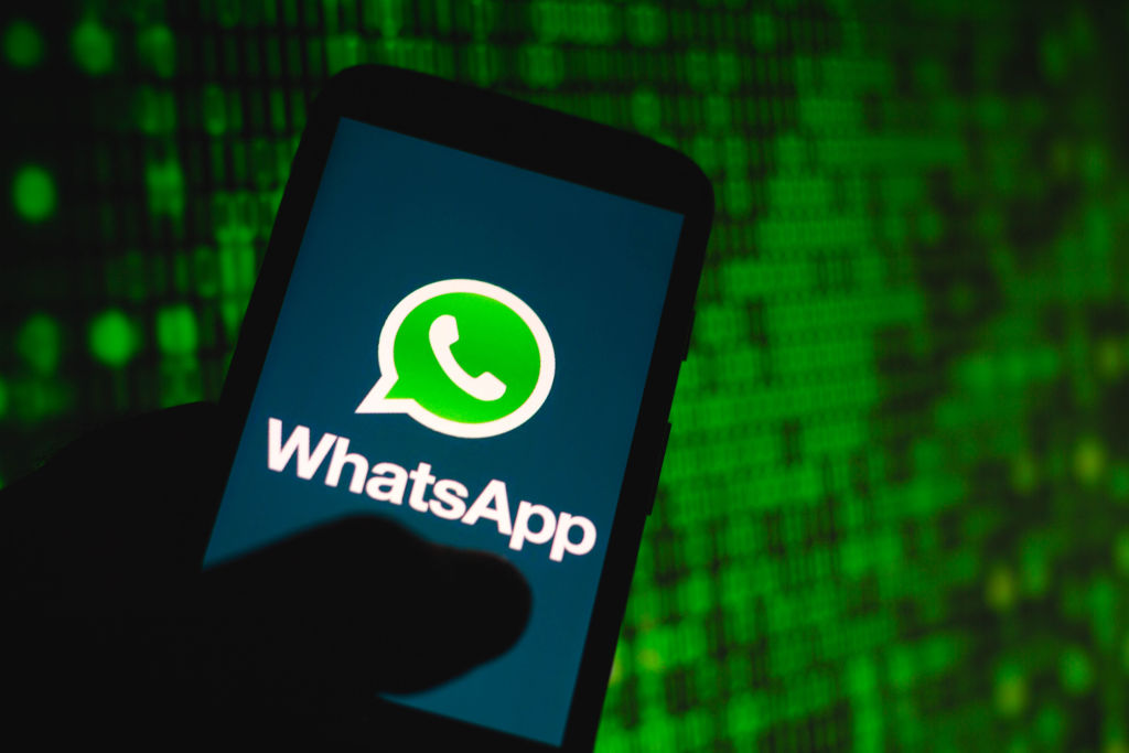 In this photo illustration the WhatsApp logo seen displayed