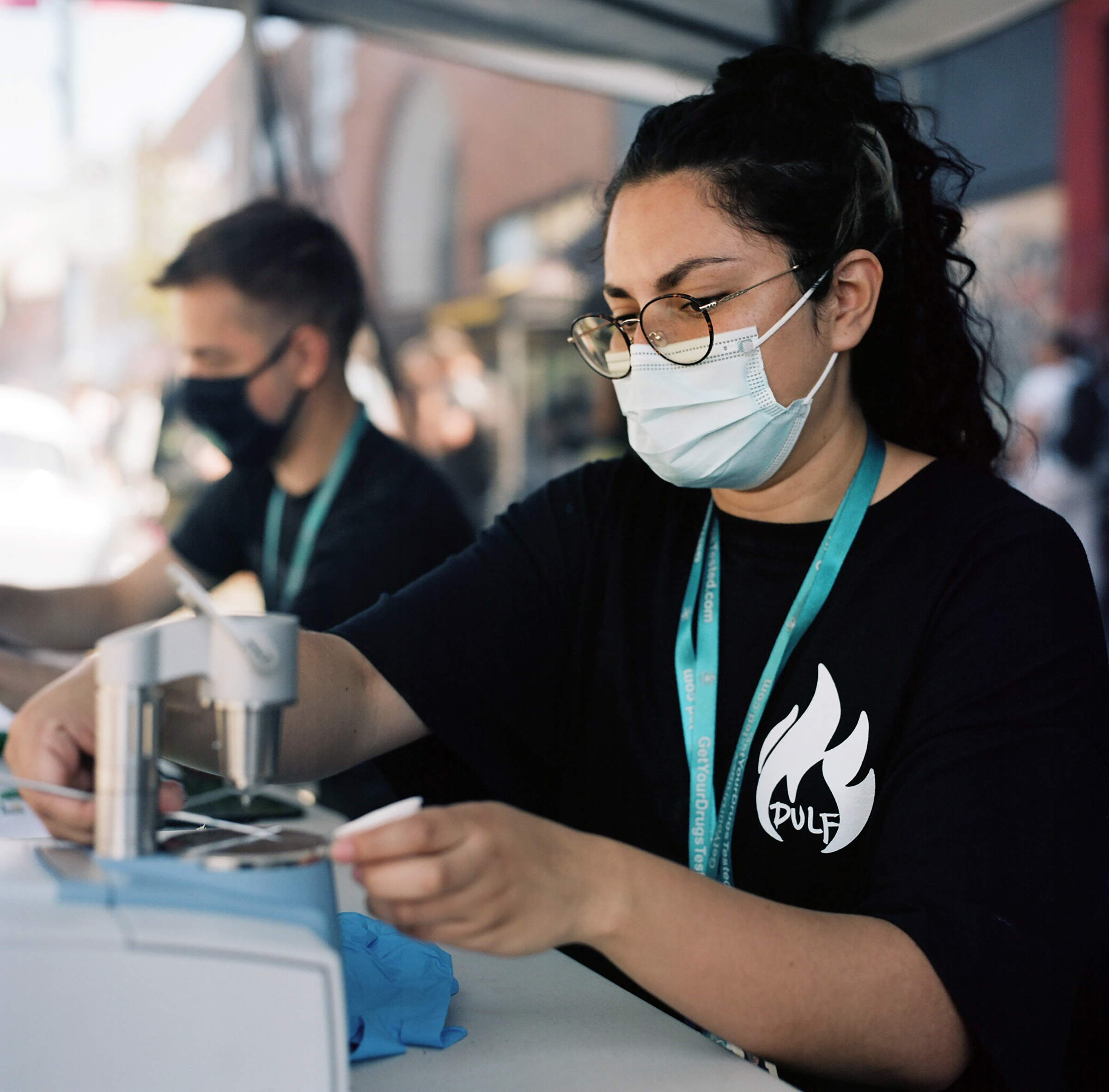 Sara Guzman uses an FTIR spectometry device to test drugs that people bring to a tent hosted by Get Your Drugs Tested Harm Reduction Center at the most recent  DULF demonstration in Vancouver B.C. on July 14, 2021. Jackie Dives