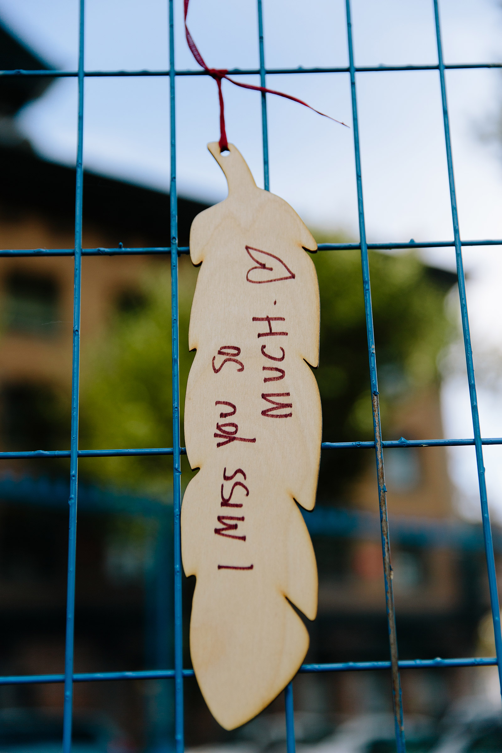 Wooden feathers that have the names of people who have died from toxic drug supply hang from a fence around Oppenheimer Park in Vancouver, B.C. August 31, 2021. Jackie Dives