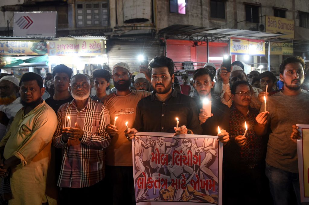 Indian Muslims holding candles and posters as they participate in a protest against the mob lynching of Tabrez Ansari in the Jharkhand state, in Ahmedabad on June 27, 2019. (SAM PANTHAKY/AFP via Getty Images)