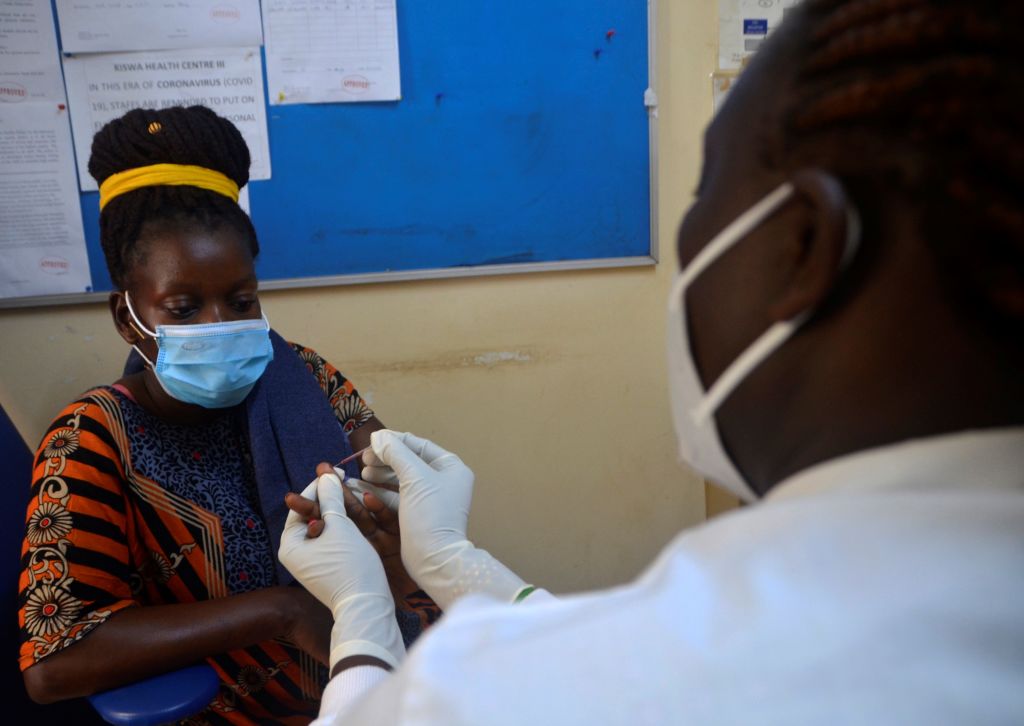 A health worker performs a rapid diagnostic test during a one-day malaria health camp in Kampala, Uganda, April 26, 2021. (Nicholas Kajoba/Xinhua via Getty)