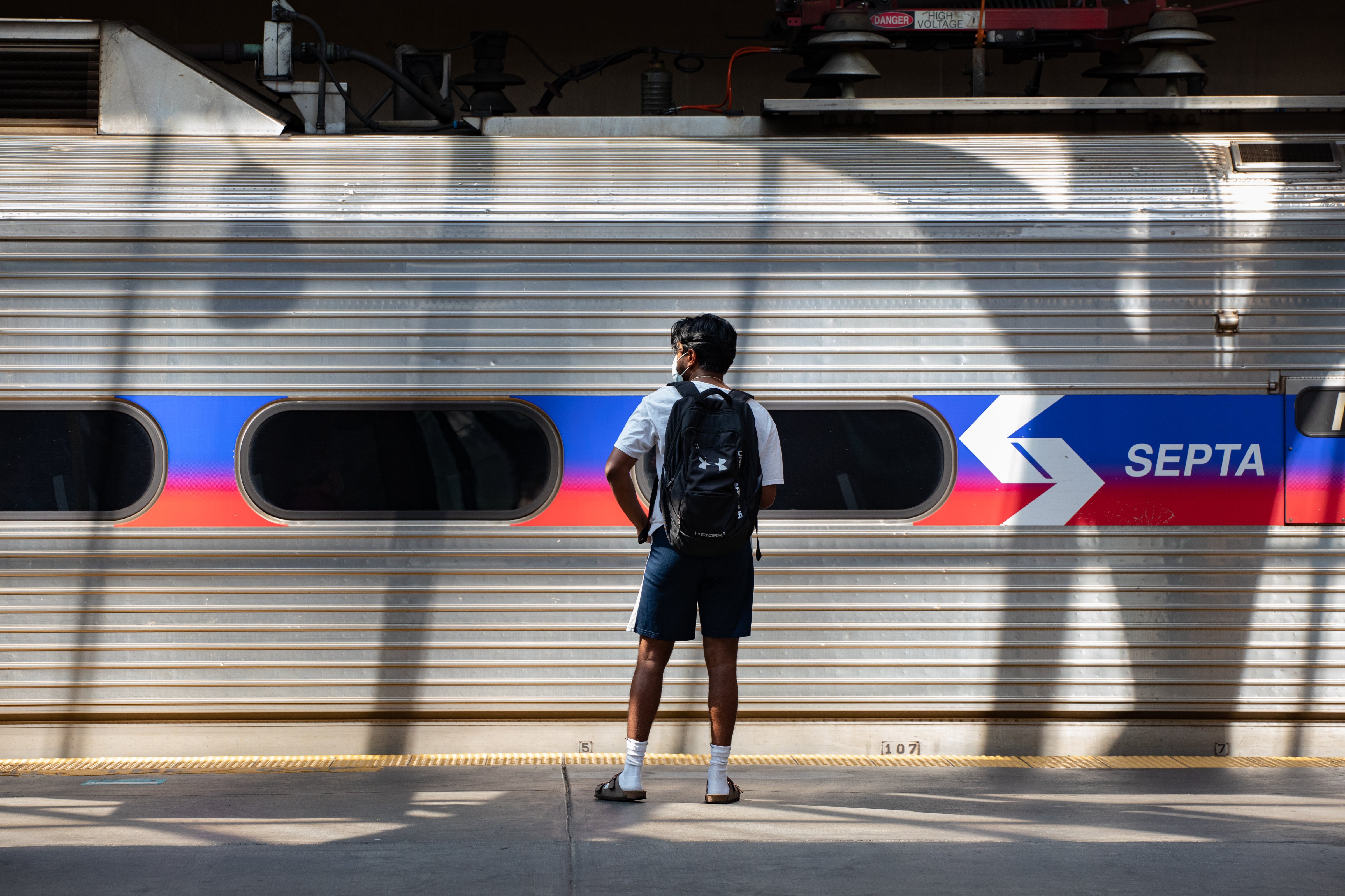 A passenger waits on a SEPTA train platform at a commuter rail station in Philadelphia on July 30, 2021. (Hannah Beier—Bloomberg/Getty Images)