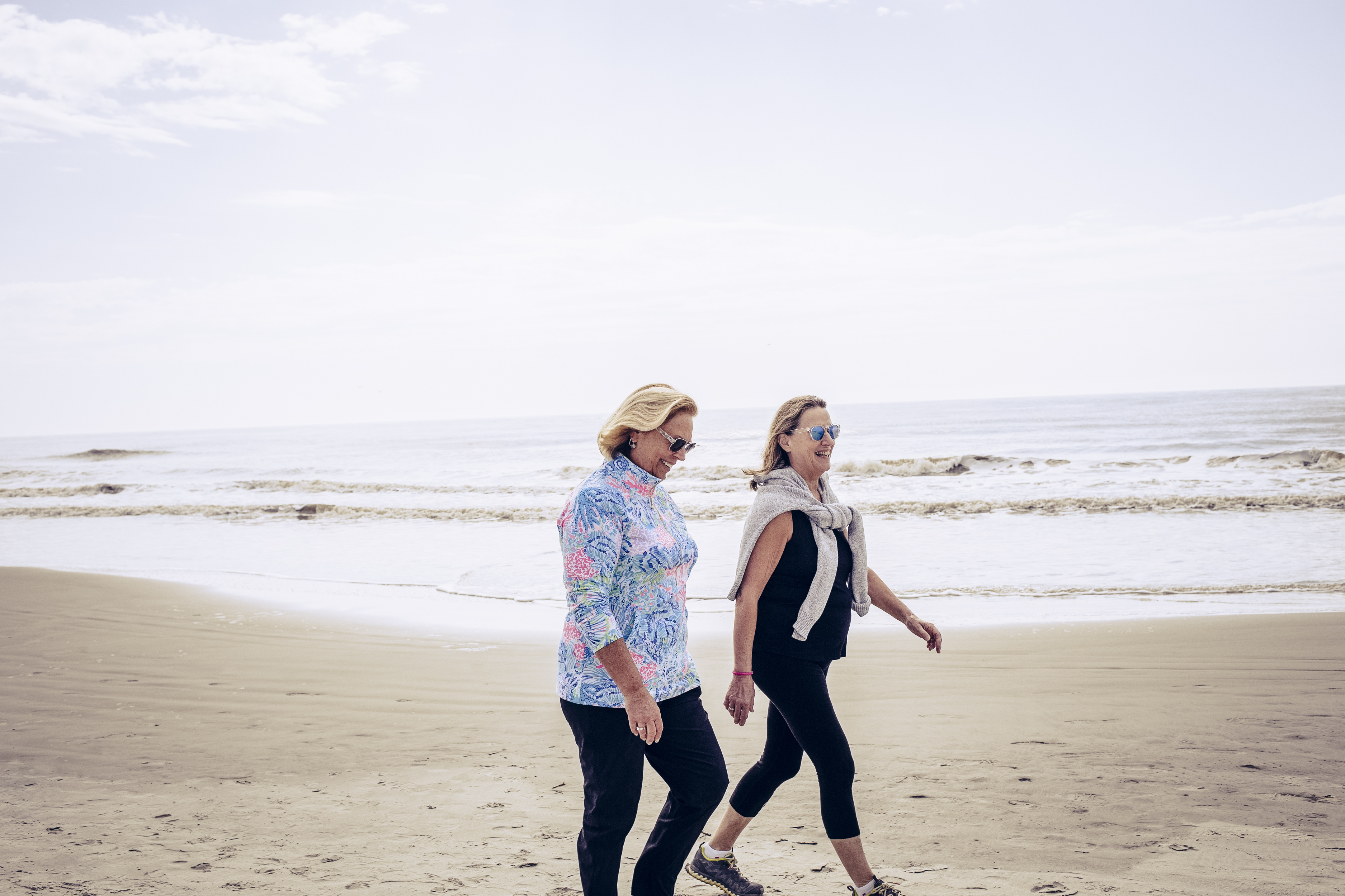 Senior women enjoying walk on beach
