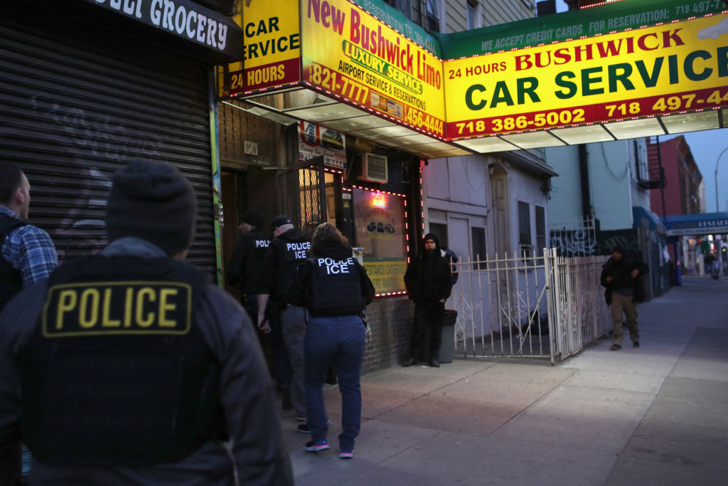 U.S. Immigration and Customs Enforcement (ICE) officers stage a raid to arrest an undocumented immigrant in New York City on April 11, 2018. (John Moore—Getty Images)