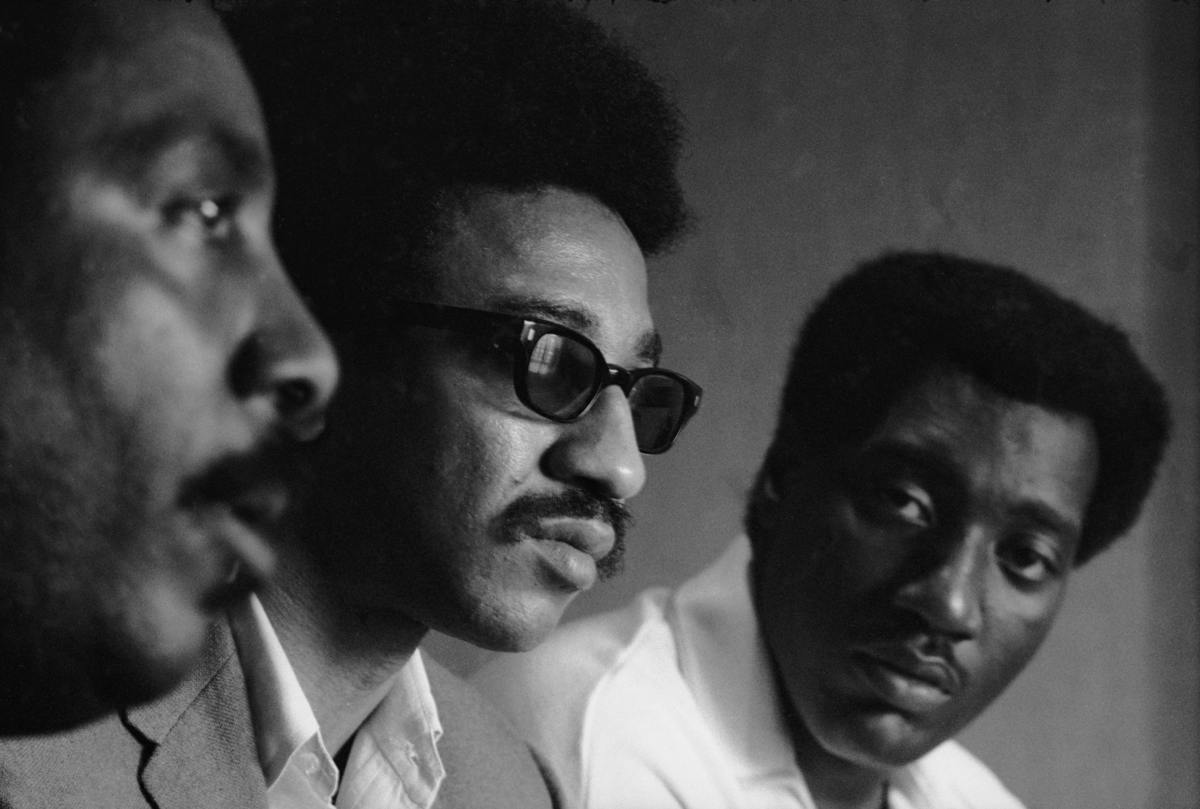 Civil rights activist Dick Gregory, left, and musician Otis Redding flank H. Rap Brown at an August 1967 convention in Atlanta (Vernon Merritt III—Getty Images)