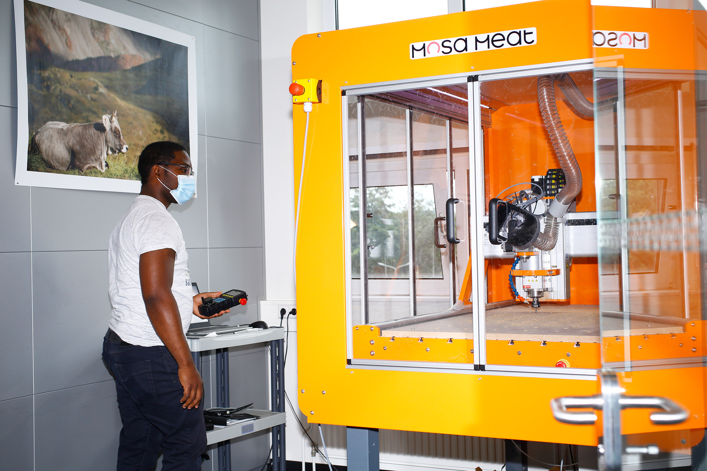 Josias Mouafo stands in front of a CNC (computer numerical control) machine which makes custom made parts for Mosa's processes. (Ricardo Cases for TIME)