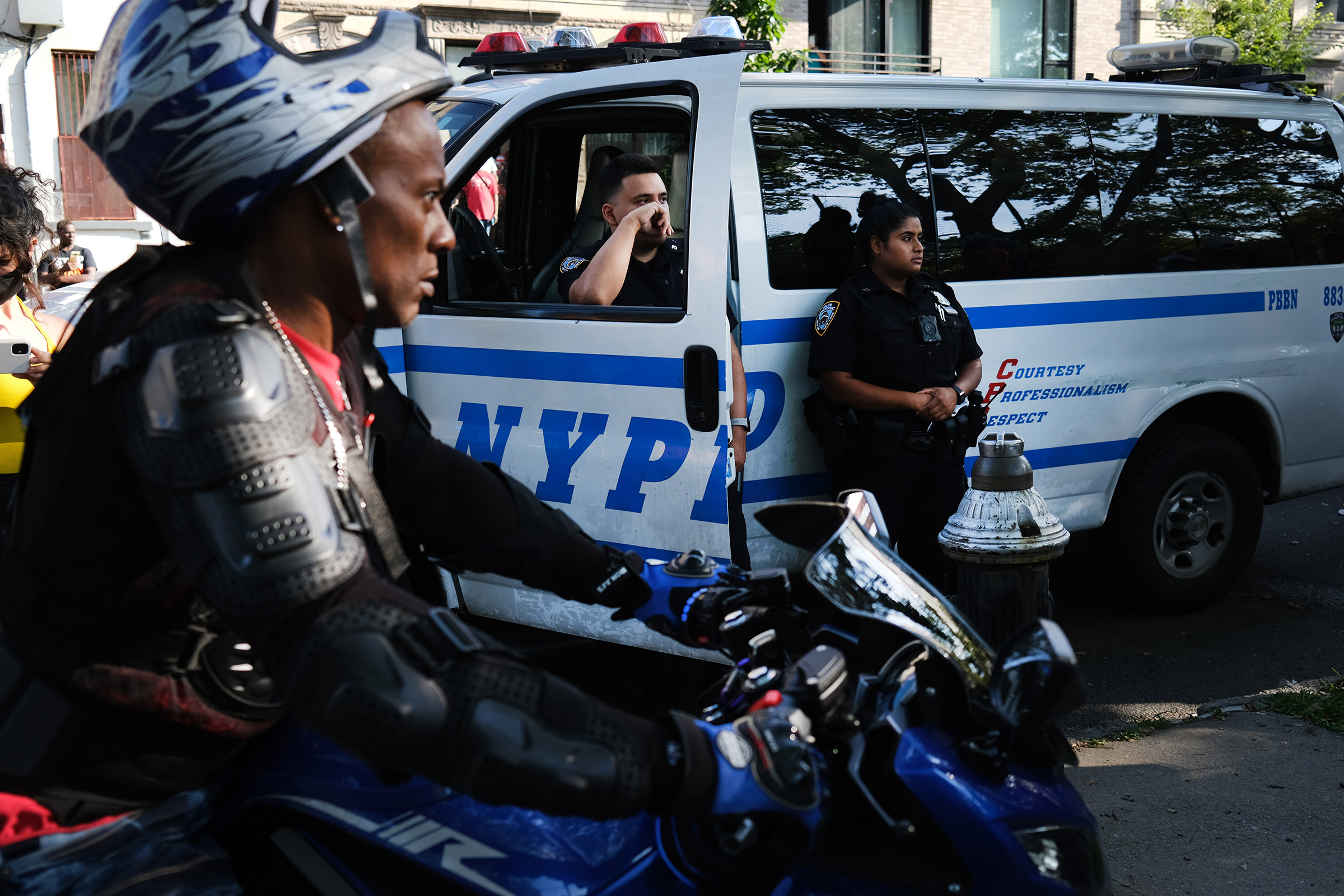 Police watch as SOS members hold a peace march in response to a surge in shootings in the Bedford-Stuyvesant neighborhood in Brooklyn on July 16, 2020. (Spencer Platt—Getty Images)