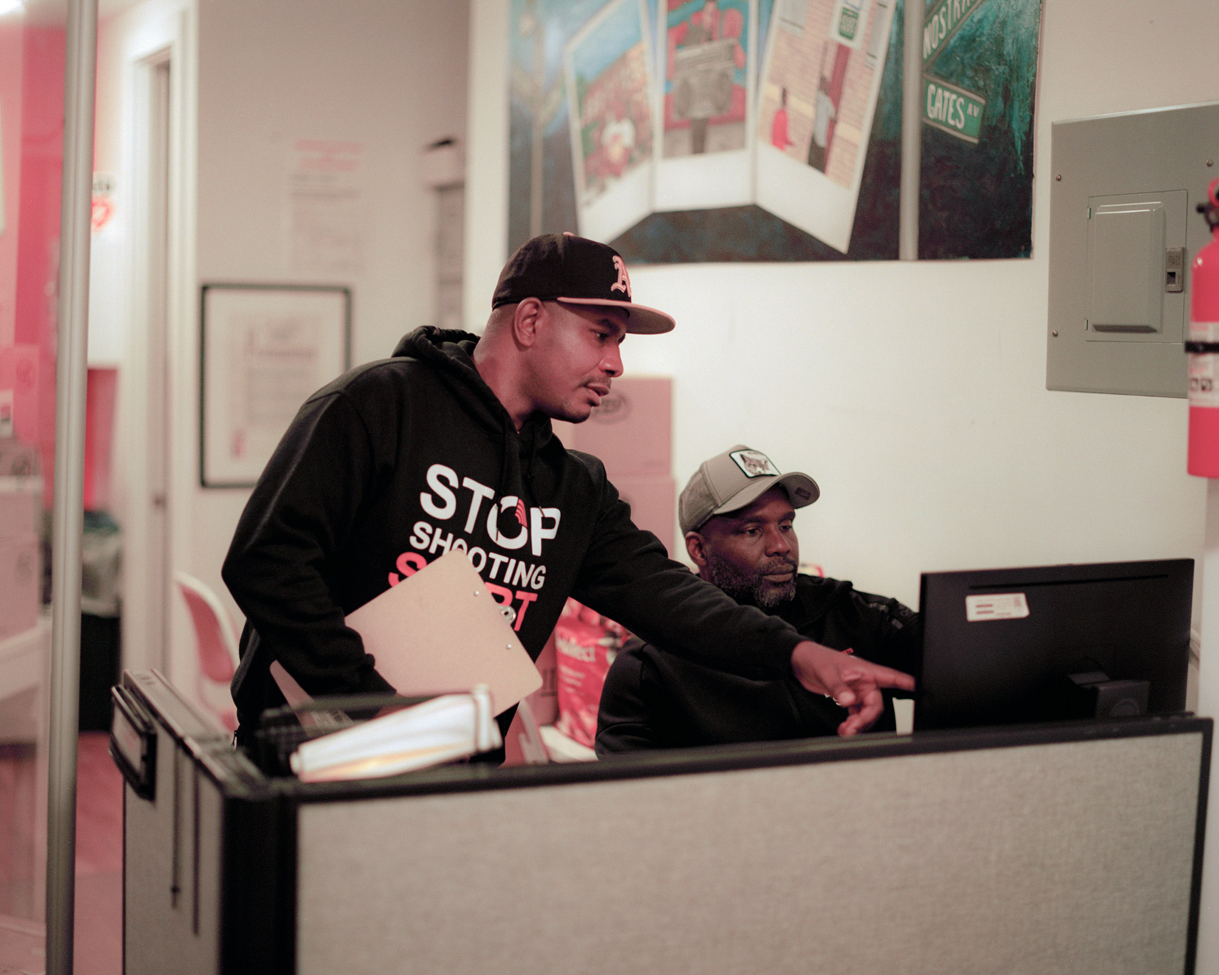 Rahson Johnson, left, and Joshua Simon, right, work in the S.O.S. offices in the Bed-Stuy neighborhood in Brooklyn, New York on October 8, 2021.