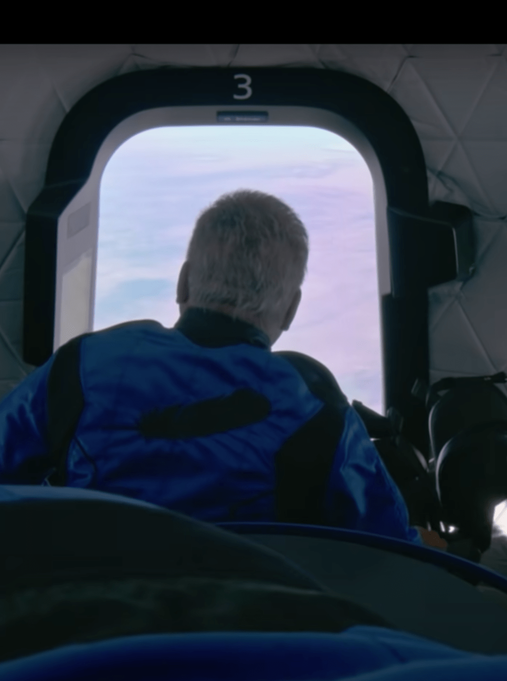 William Shatner, 90, the oldest man to travel to space, looks out the window of Blue Origin's New Shepard suborbital rocket on Oct. 13, 2021 (Blue Origin livestream)