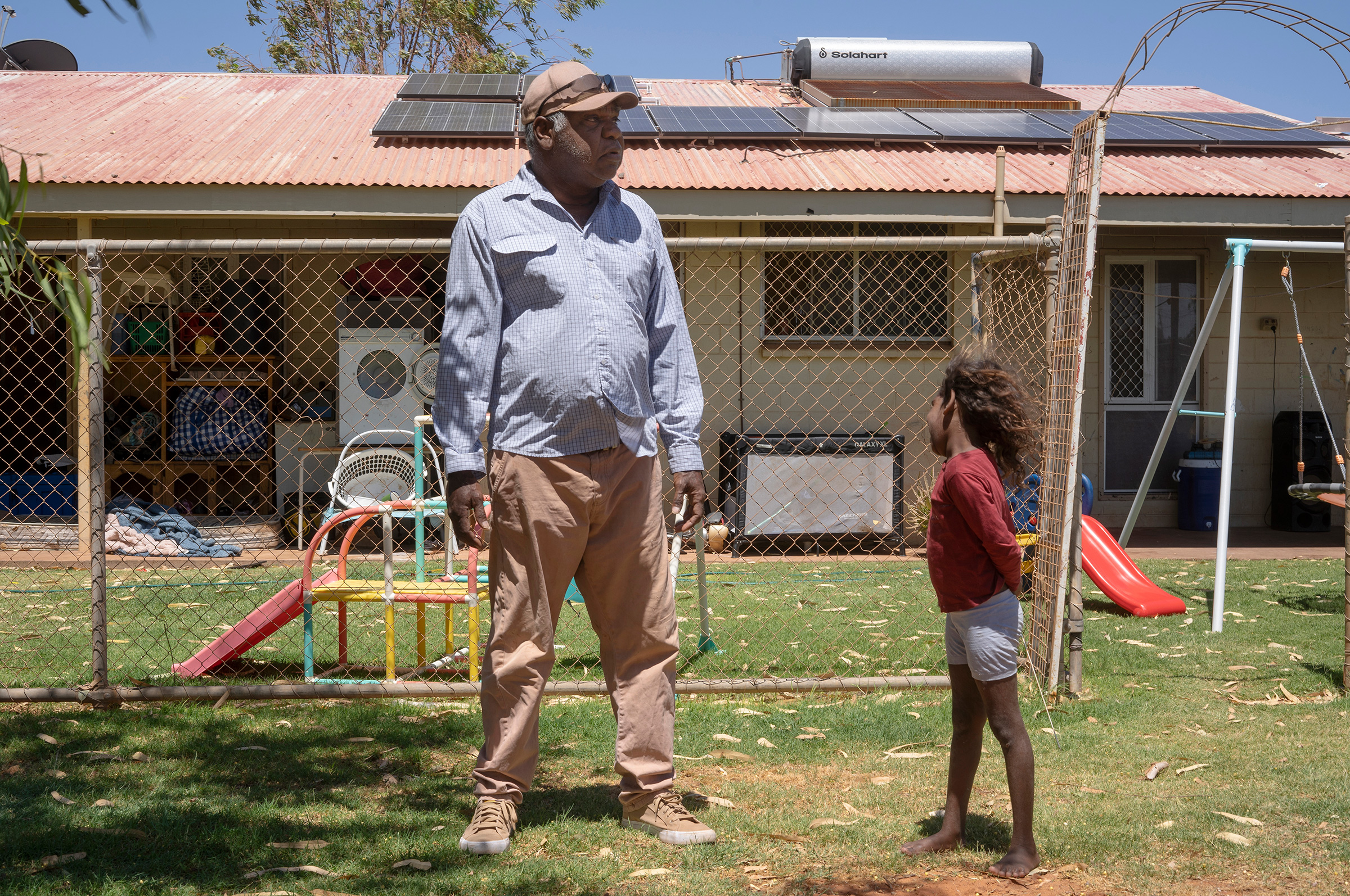 Frank in front of his Tennant Creek home. His local energy provider isn’t able to connect the solar panels on his roof to the grid, making them functionally useless