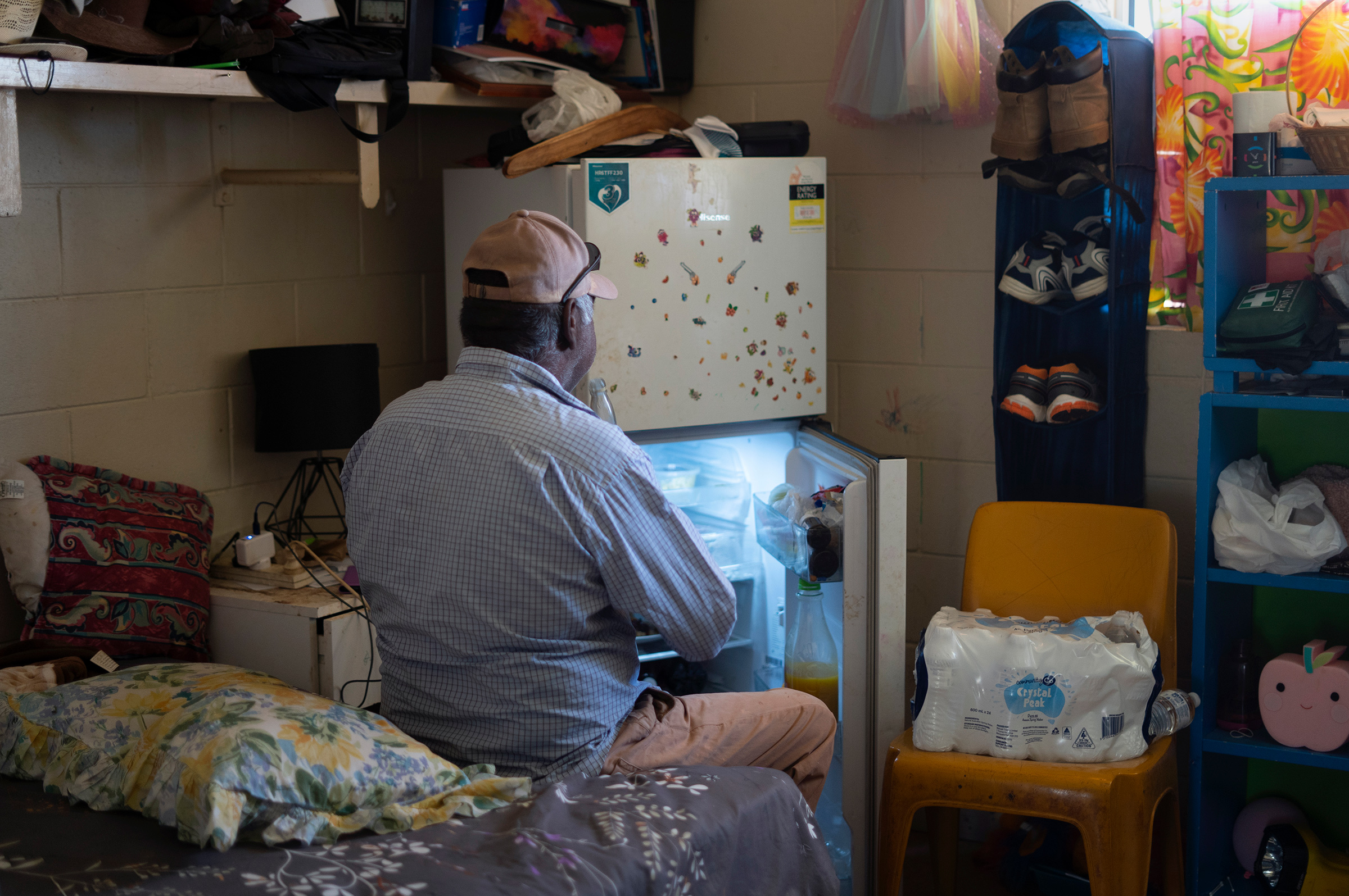 Norman Frank sits by his fridge where he keeps his medication (Aneeta Bhole—SBS)