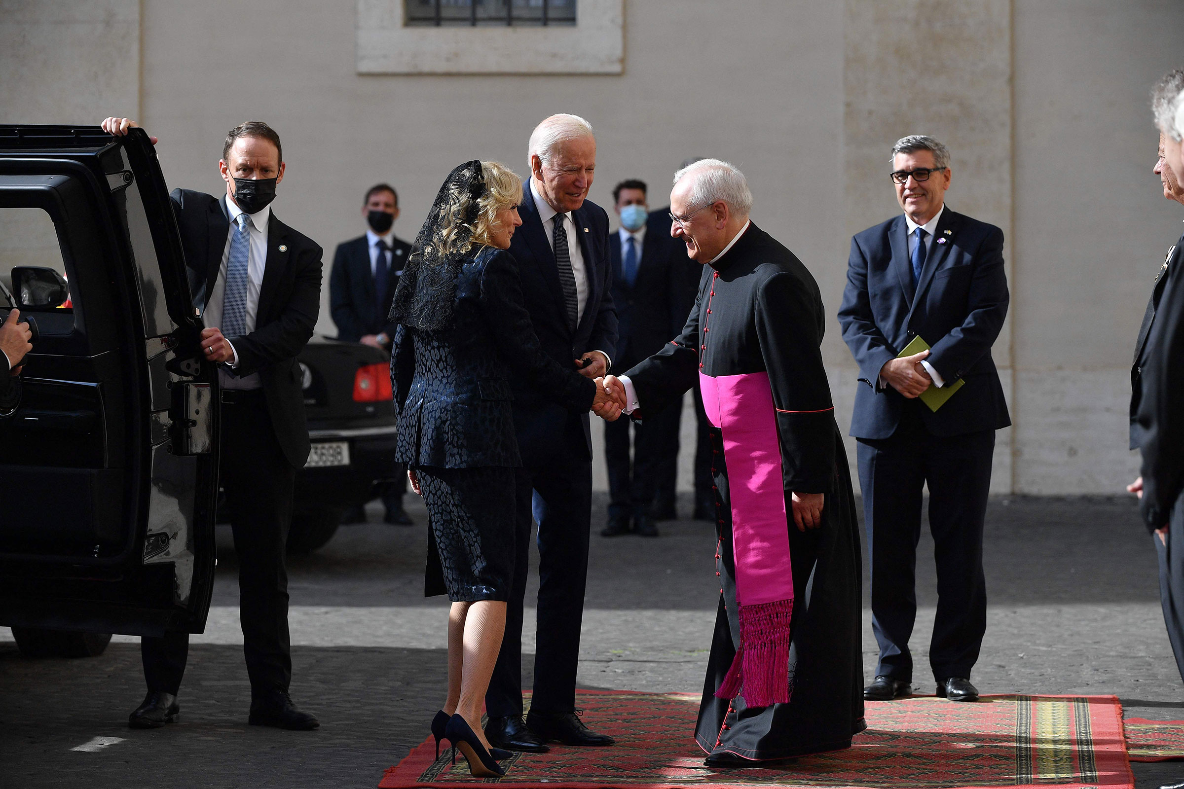 U.S. President Joe Biden and First Lady Jill Biden are greeted by the Head of the Papal Household, Mons. Leonardo Sapienza, as they arrive at San Damaso courtyard in The Vatican on October 29, 2021 for a private audience with the Pope. (Tiziana Fabi—AFP/Getty Images)