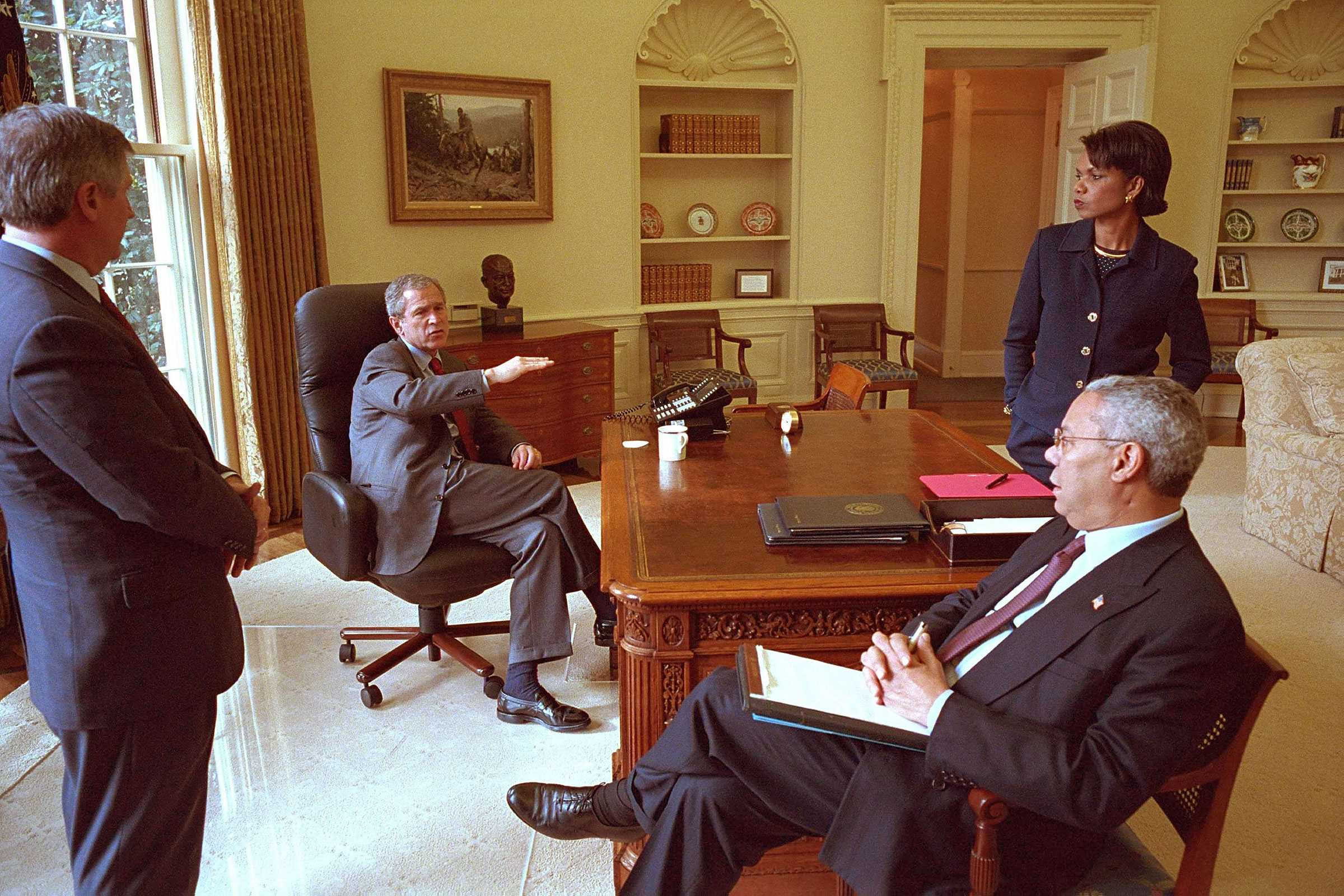 President George W. Bush meets with Chief of Staff Andy Card, Secretary of State Colin Powell, and National Security Advisor Condoleezza Rice in the Oval Office, 2001. (Eric Draper—White House/Getty Images)