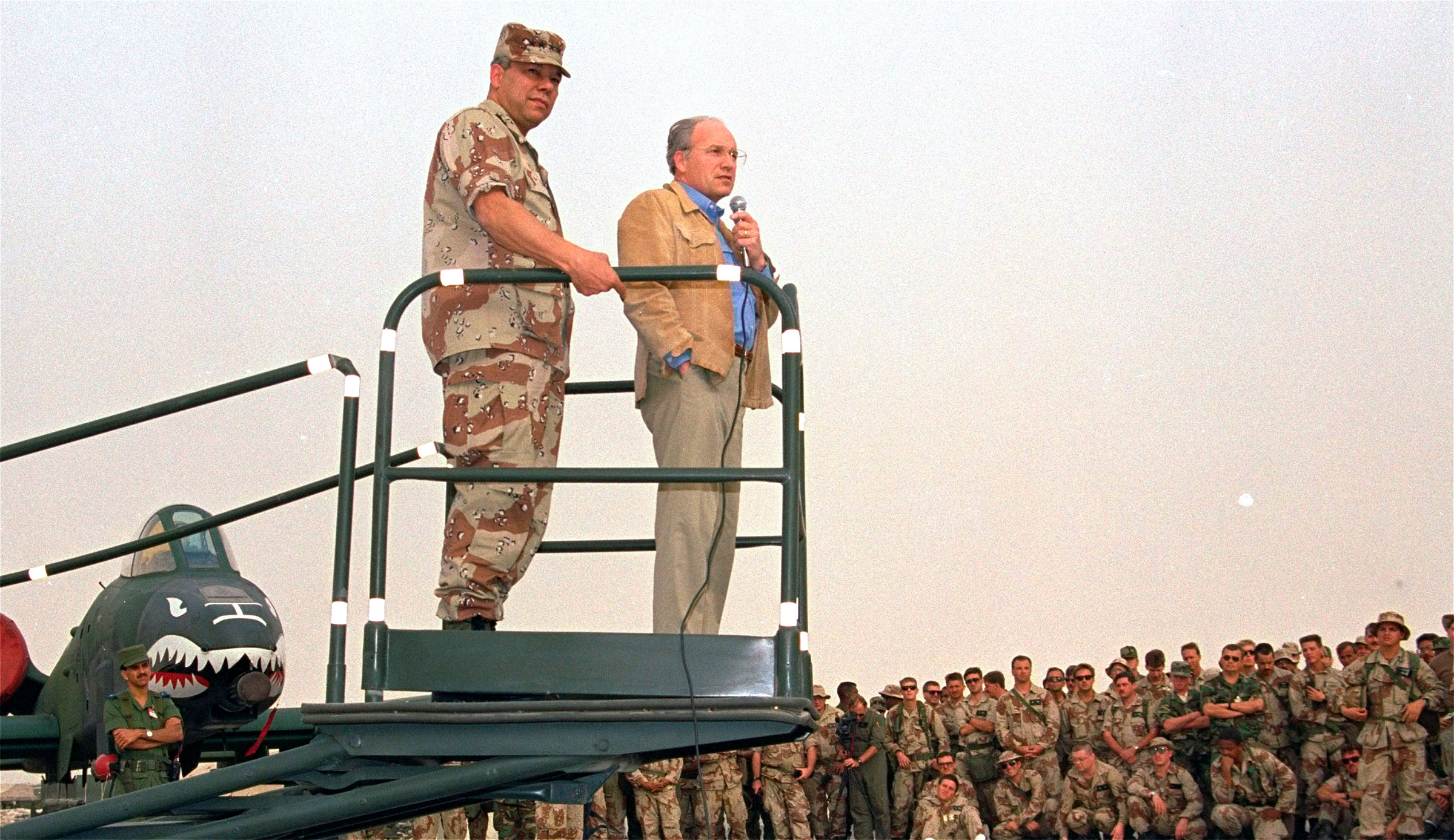 Secretary of Defense Dick Cheney, right, and Gen. Colin Powell, chairman of the Joint Chiefs of Staff, speak to members of the 354th Tactical Fighter Wing from Myrtle Beach, S.C. at their air base in Saudi Arabia on Dec. 12, 1990. (Bob Daugherty—AP)