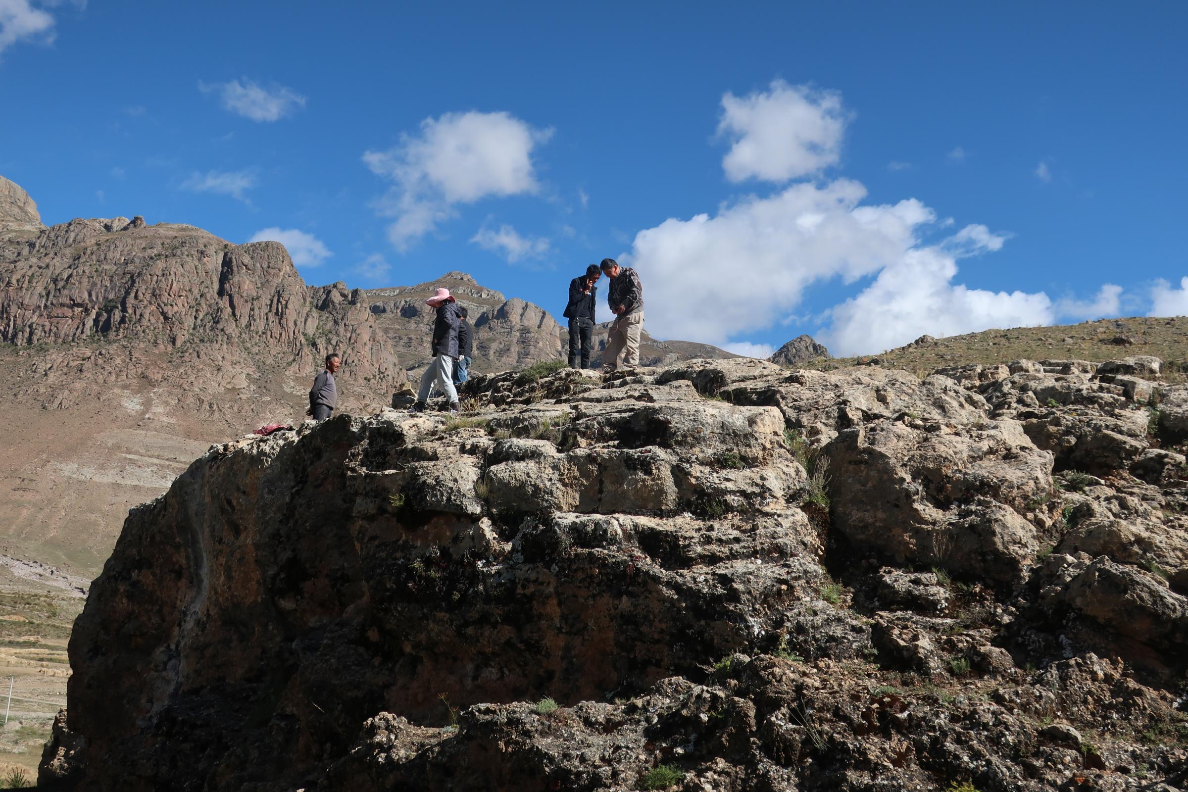 The team led by Dr. David Zhang from Guangzhou University in China visits the research site in Quesang, Tibet where human footprints and handprints thought to be the earliest known cave art were discovered.