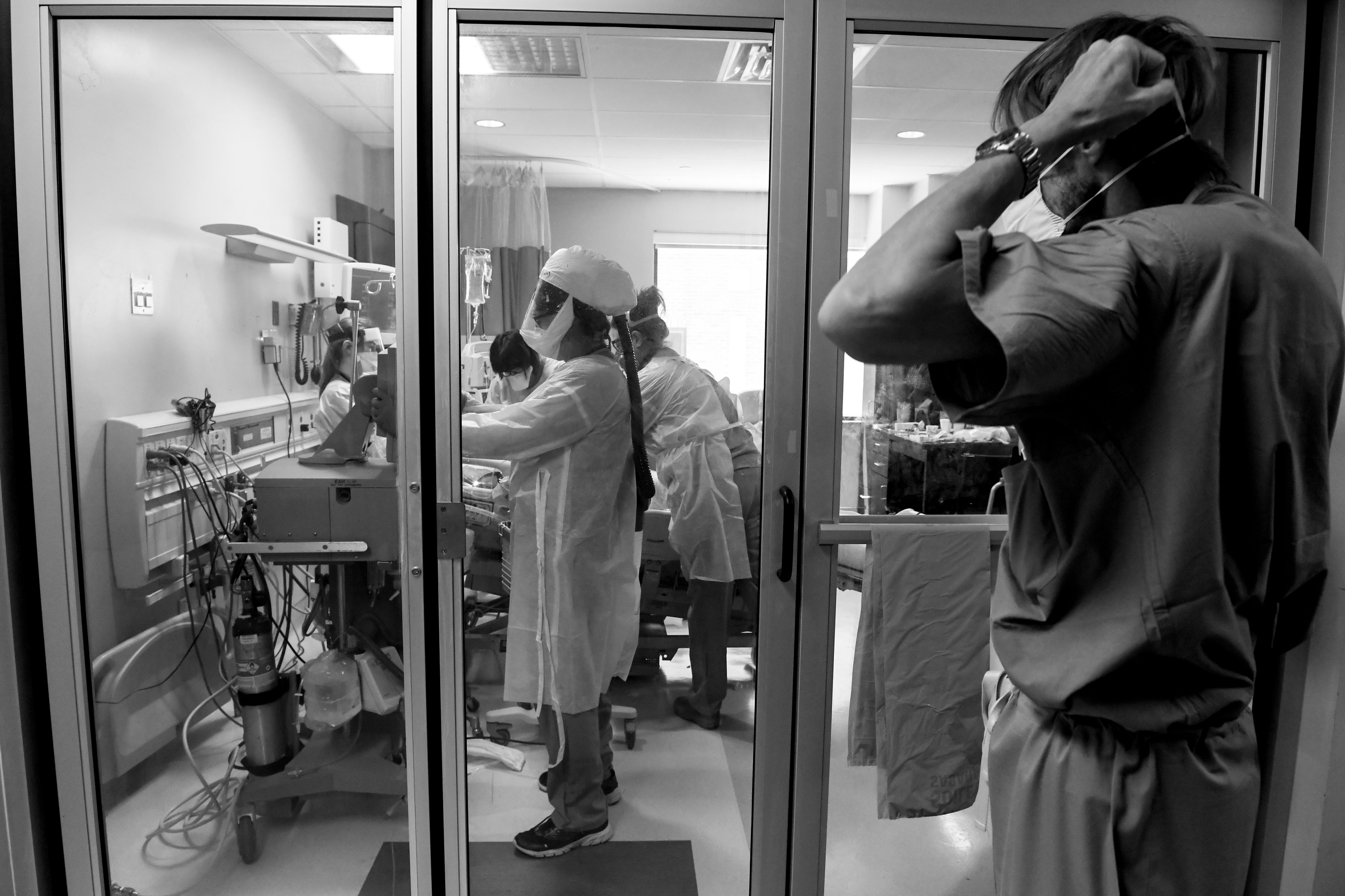 A team of nurses and a respiratory therapist work with a patient in the ICU Covid ward as a doctor masks up at the Medical Center of Aurora on Tuesday, May 27, 2020. (AAron Ontiveroz—MediaNews Group/The Denver Post via Getty Images)