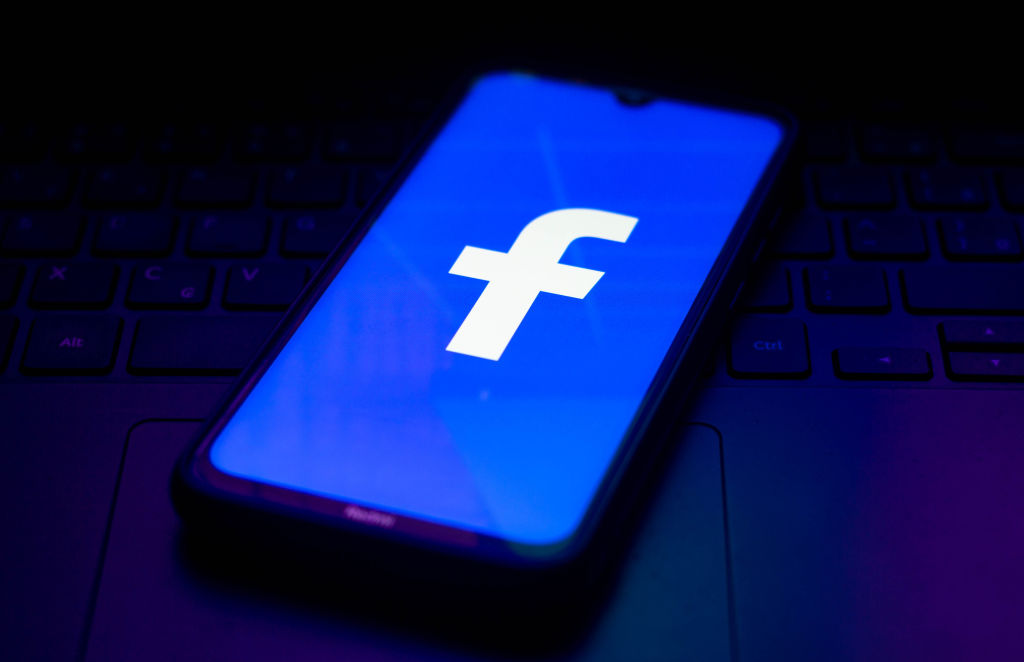 In this photo illustration the Facebook logo seen displayed