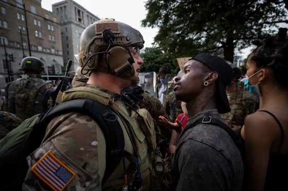 In this June 3, 2020, file photo, a demonstrator stares at a National Guard soldier as protests continue over the death of George Floyd, near the White House in Washington, D.C. 