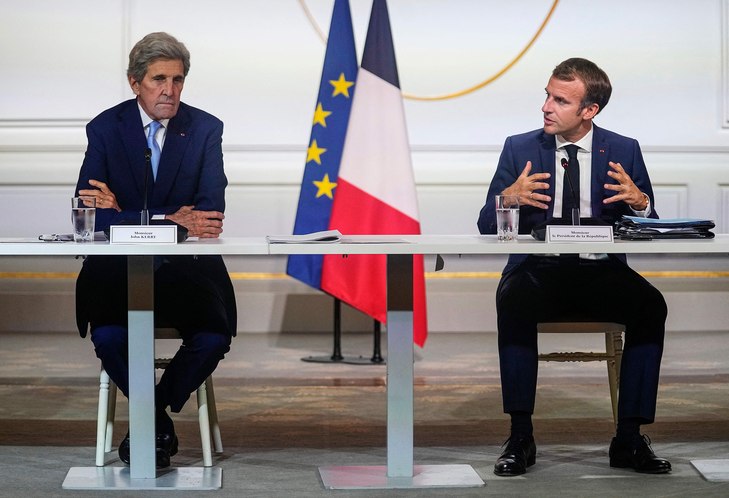 Kerry with French President Emmanuel Macron (Michel Euler—POOL/AFP/Getty Images)