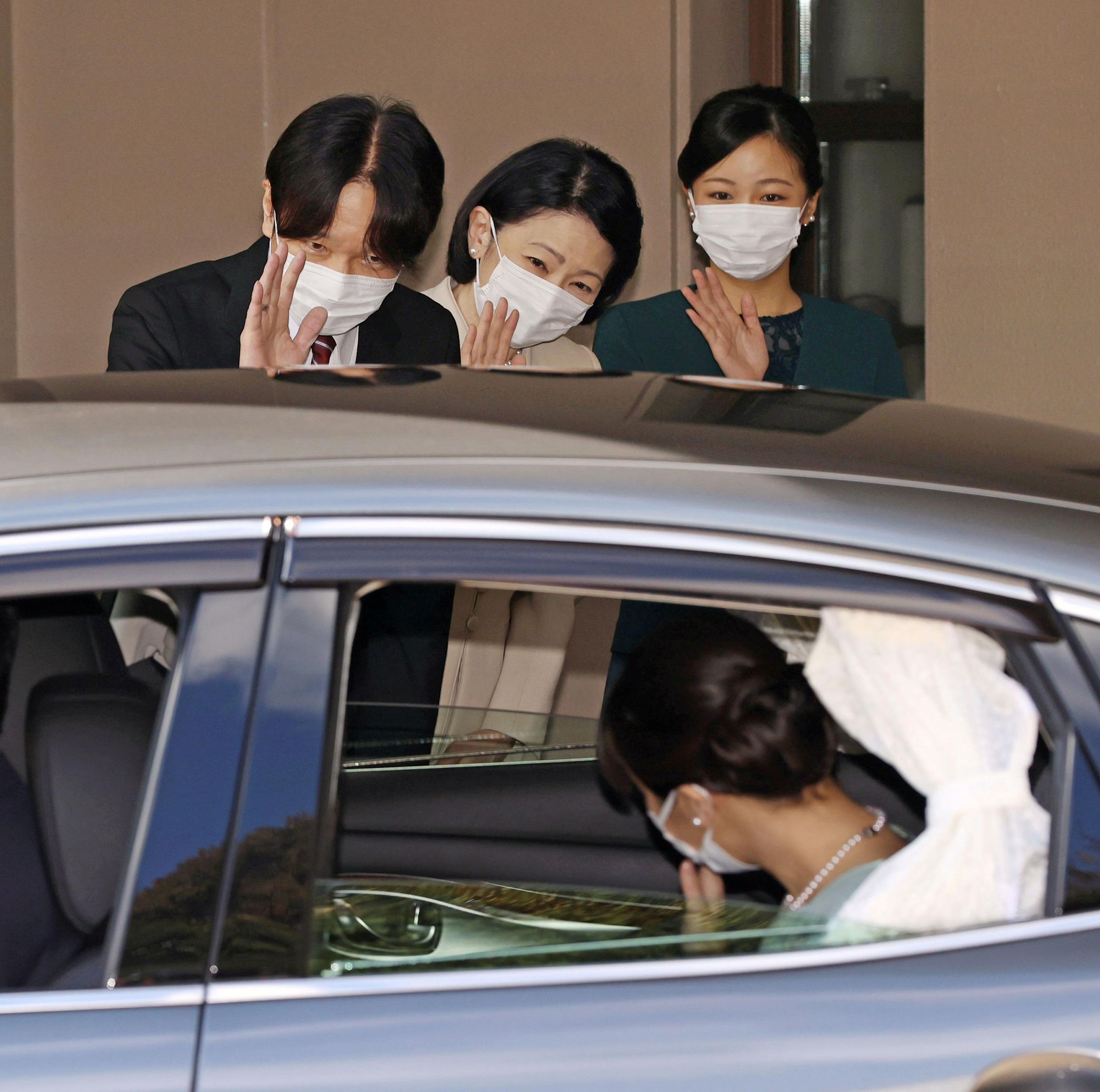 Prince Akishino, Princess Kiko and Princess Kako wave to Princess Mako leaving her home for her marriage in Akasaka Estate in Tokyo on Oct. 26. (Kyodo/Reuters)