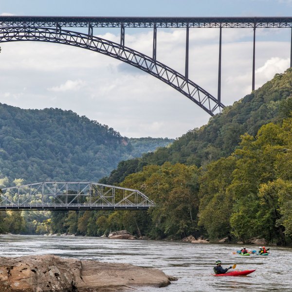 Kayakers under the New River Gorge Bridge in Fayetteville, West Virginia.