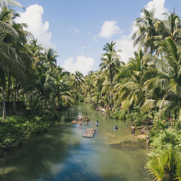 People swim on the Maasin River on Siargao in the Philippines.
