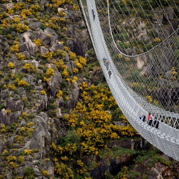 People walk on the world's longest pedestrian suspension bridge '516 Arouca', now open for local residents in Arouca, Portugal, April 29, 2021.