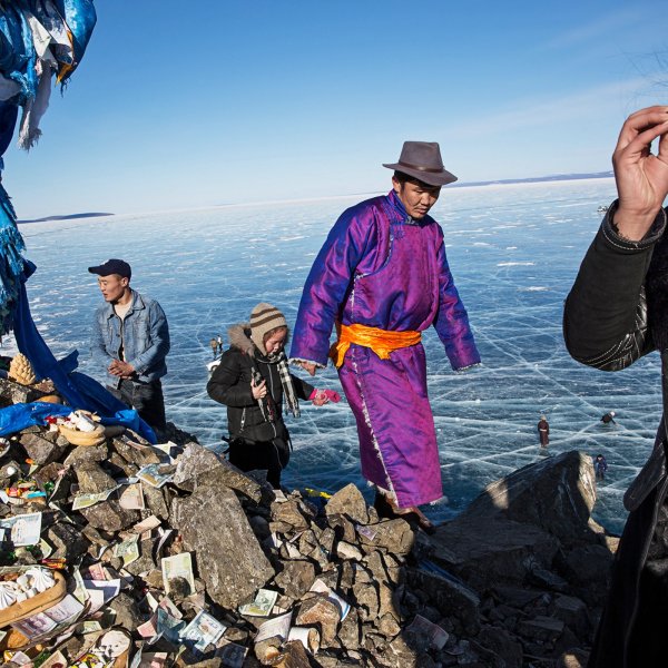 Mongolian men and women pray and make offerings at an Ovoo near the Lake Khovsgol Ice Festival in Khatgal, Mongolia.