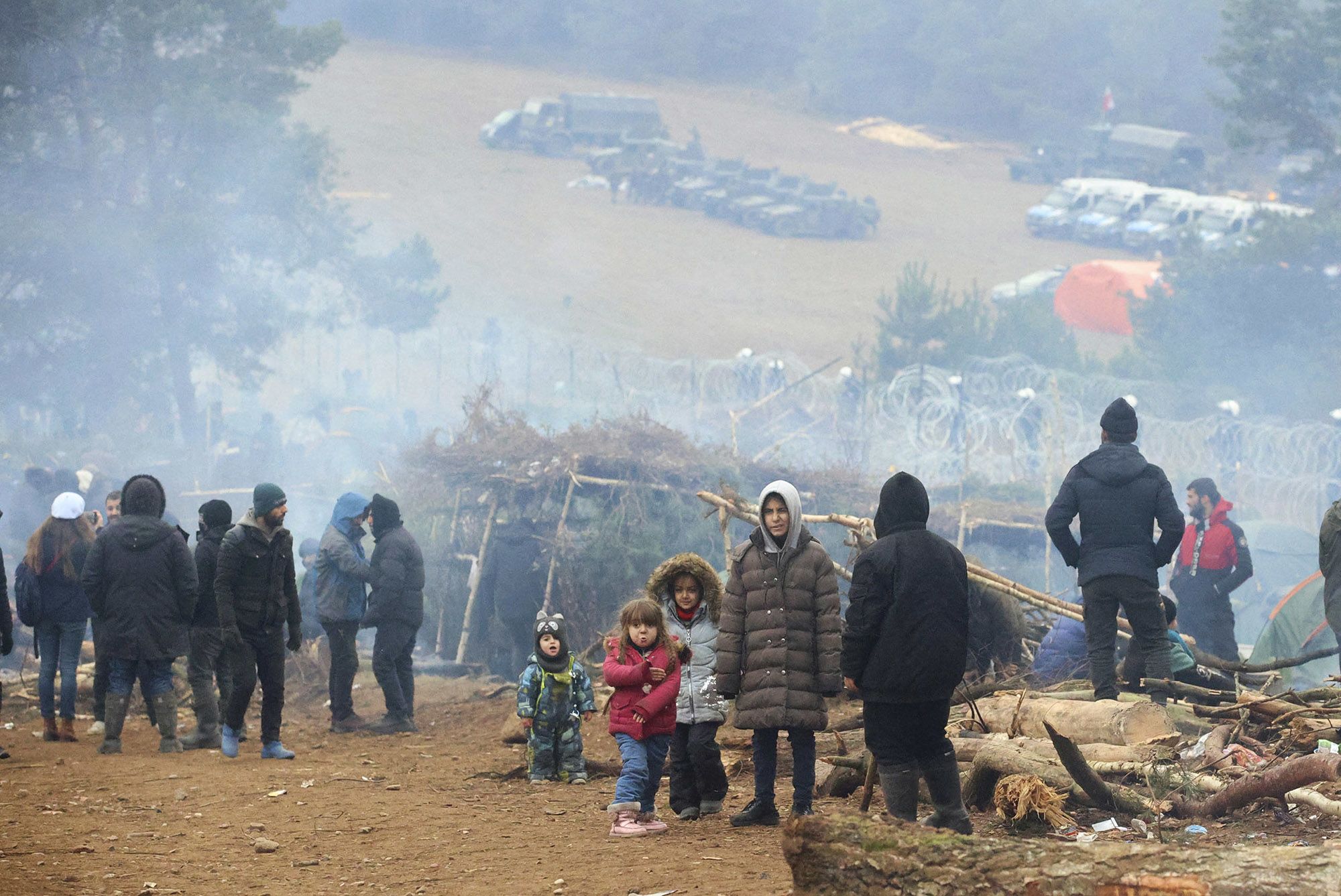 A group of migrants are seen in a camp near the Belarusian-Polish border in the Grodno region on November 13, 2021. (Leonid Shcheglov/AFP/Getty Images)