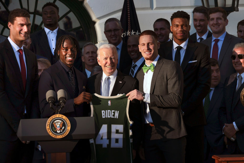 President Joe Biden poses with members of the Milwaukee Bucks after receiving a jersey from owner Marc Lasry during an event where Biden honored the Bucks for winning the 2021 NBA Championship, on the South Lawn at the White House on November 08, 2021 in Washington, D.C. (Win McNamee–Getty Images)