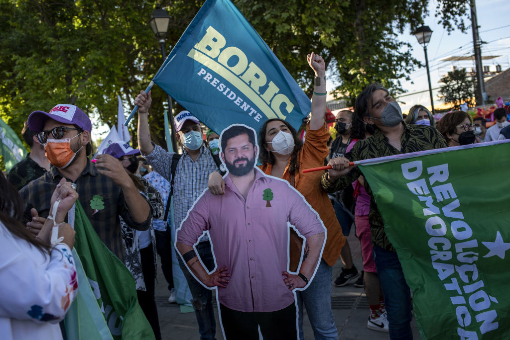 Supporters hold a cutout of Gabriel Boric, presidential candidate for the Social Convergence party, during a campaign rally ahead of the general election in Casablanca, Chile, on Thursday, Nov. 18, 2021. (Cristobal Olivares—Bloomberg/Getty Images)