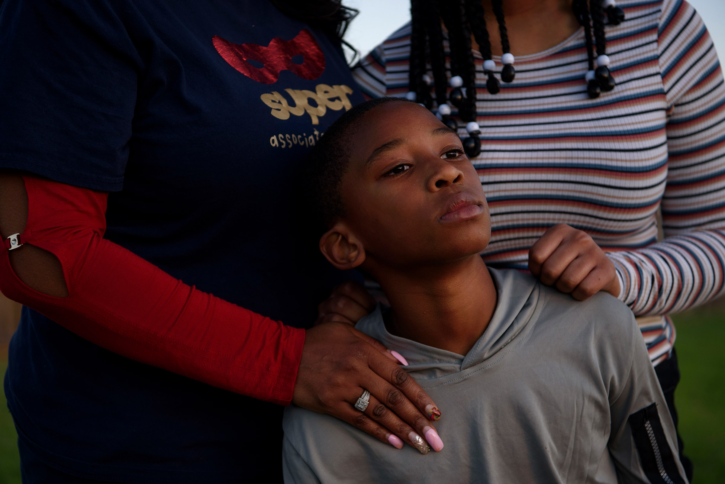 FRESNO, TX – OCTOBER 29, 2021: Adin James, 8, poses for a portrait alongside his sister, Madison, 16, and his mother, Ebony, 50, following the death of his father, Terrence James, who died after becoming ill with COVID-19, in Fresno, Texas.