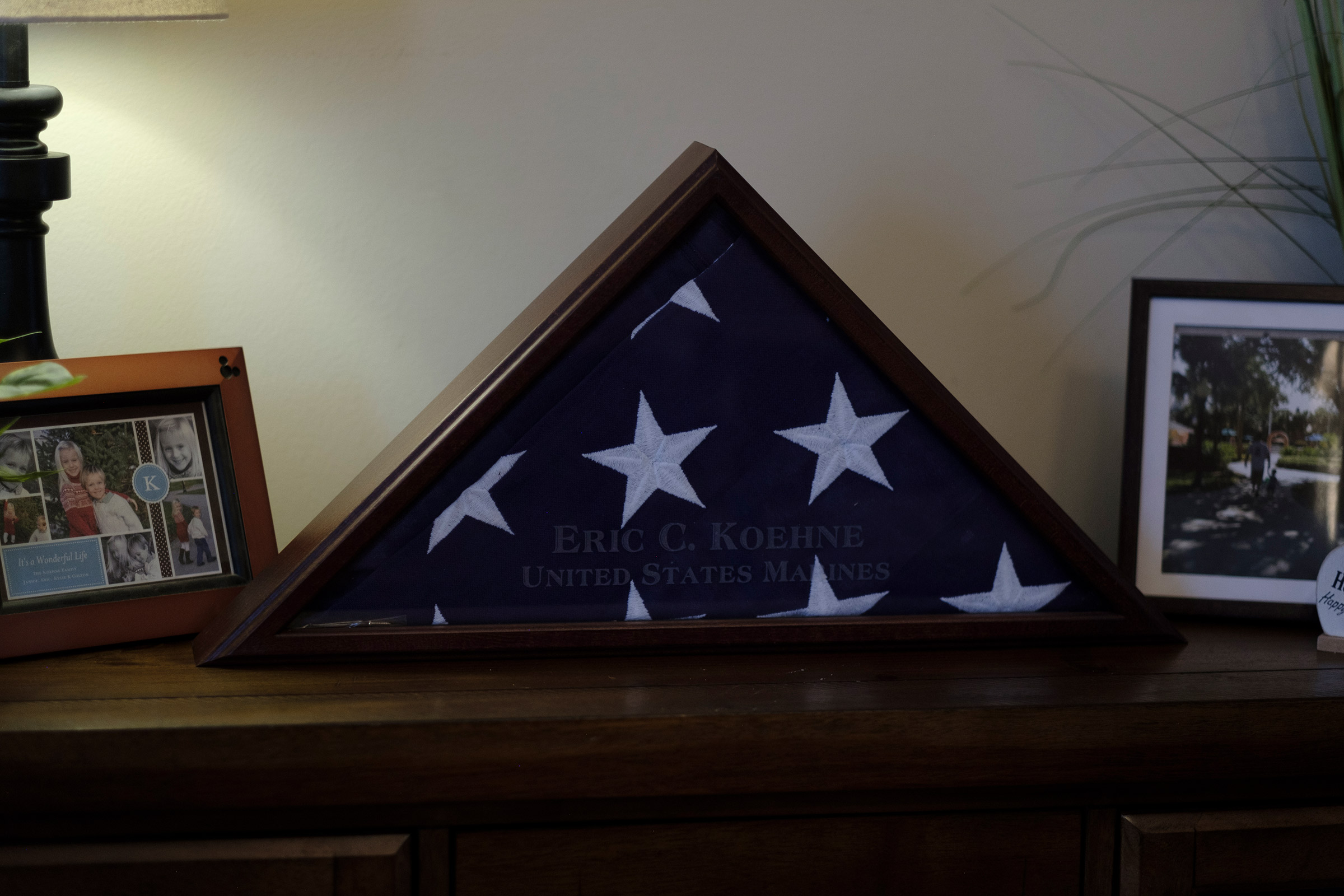 A burial flag for Eric Koehne, who passed away from COVID-19, is displayed in the living room of the Koehne family. Lyndhurst, New Jersey, 2021 © Sean Sirota for Time Magazine
