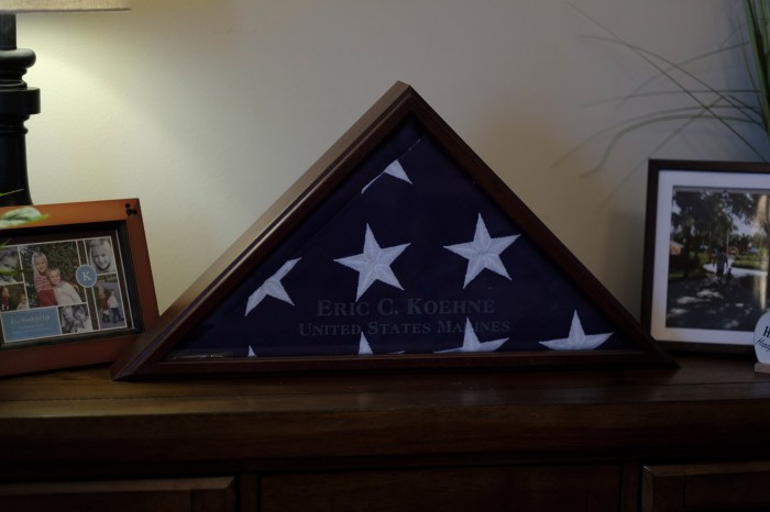A burial flag for Eric Koehne, who passed away from COVID-19, is displayed in the living room of the Koehne family. Lyndhurst, New Jersey, 2021 Â© Sean Sirota for Time Magazine