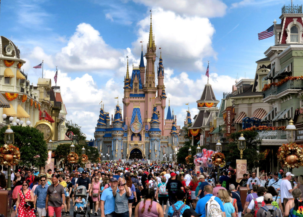 Crowds fill Main Street USA in front of Cinderella Castle at the Magic Kingdom on the 50th anniversary of Walt Disney World, in Lake Buena Vista, Fla., on Oct. 1, 2021. (Joe Burbank—Orlando Sentinel/Tribune News Service/ Getty Images))