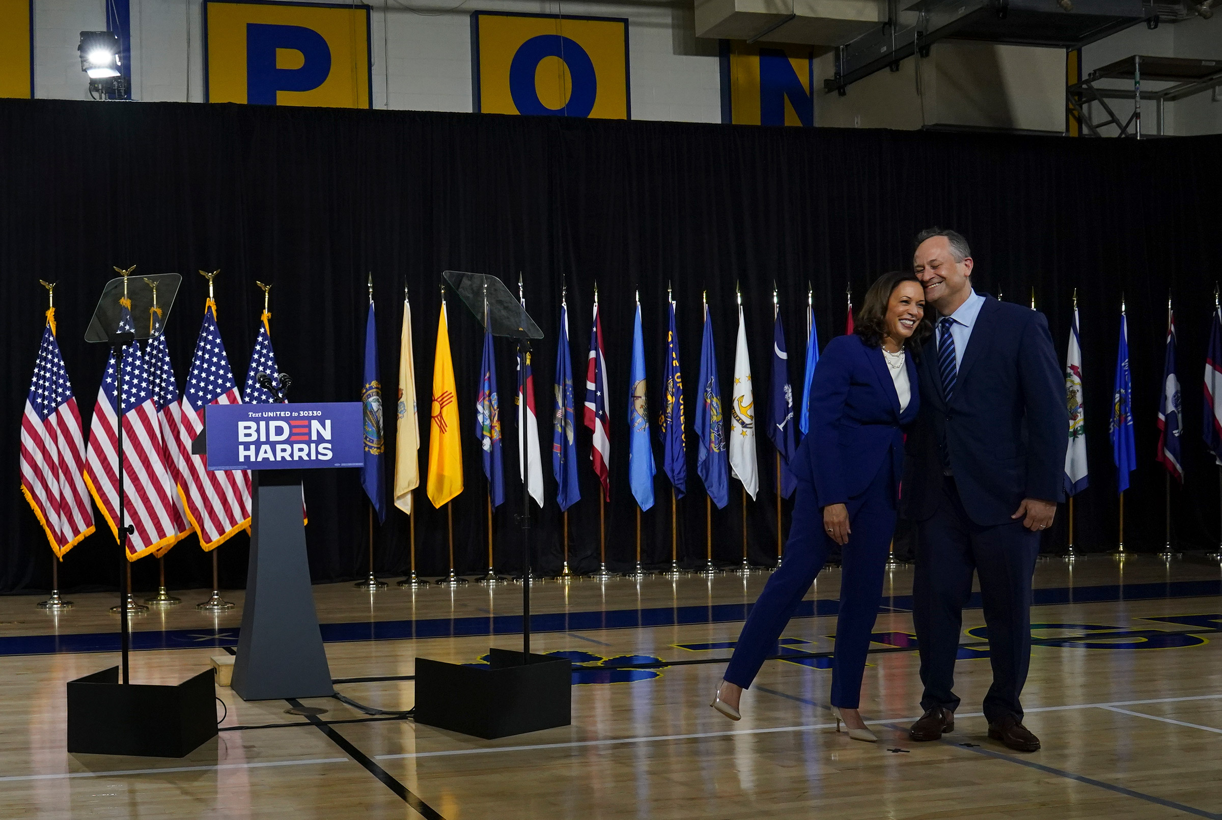 Sen. Kamala D. Harris leans on her husband Doug Emhoff after being introduced by presumptive Democratic presidential nominee Joe Biden as his running mate during an event in Wilmington, Del., on Aug. 12, 2020. (Toni L. Sandys—The Washington Post/Getty Images)