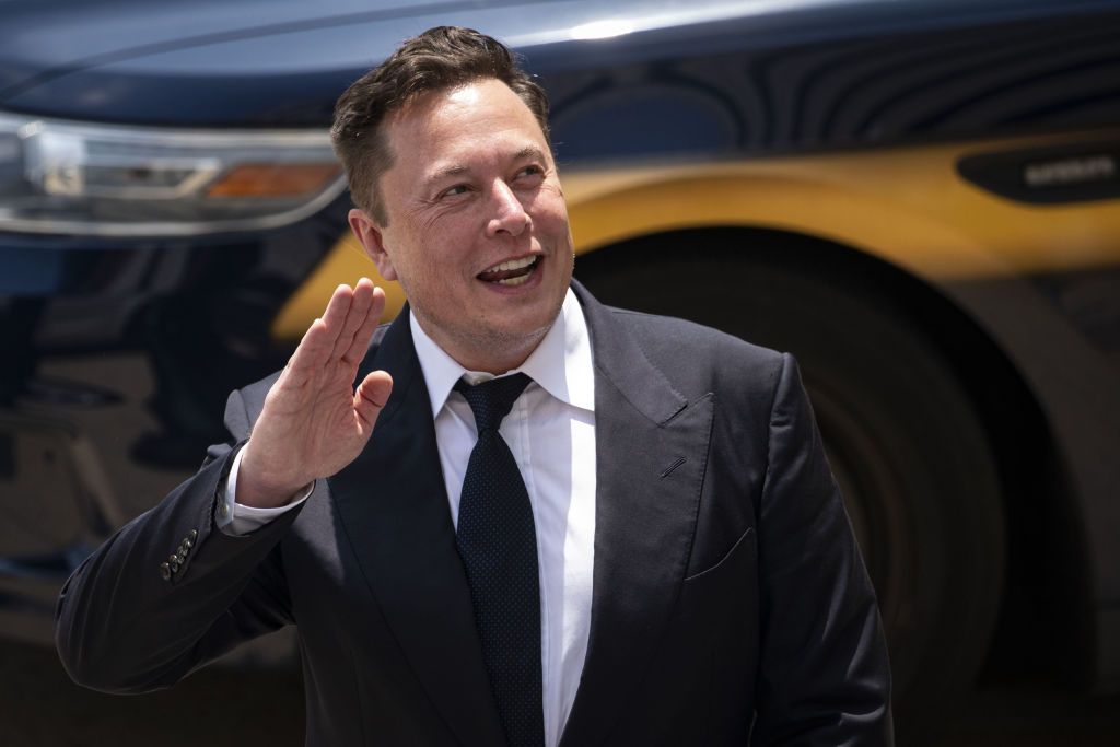 Elon Musk, chief executive officer of Tesla, waves while departing court during the SolarCity trial in Wilmington, Del. on Tuesday, July 13, 2021. (Al Drago–Bloomberg/Getty Images)