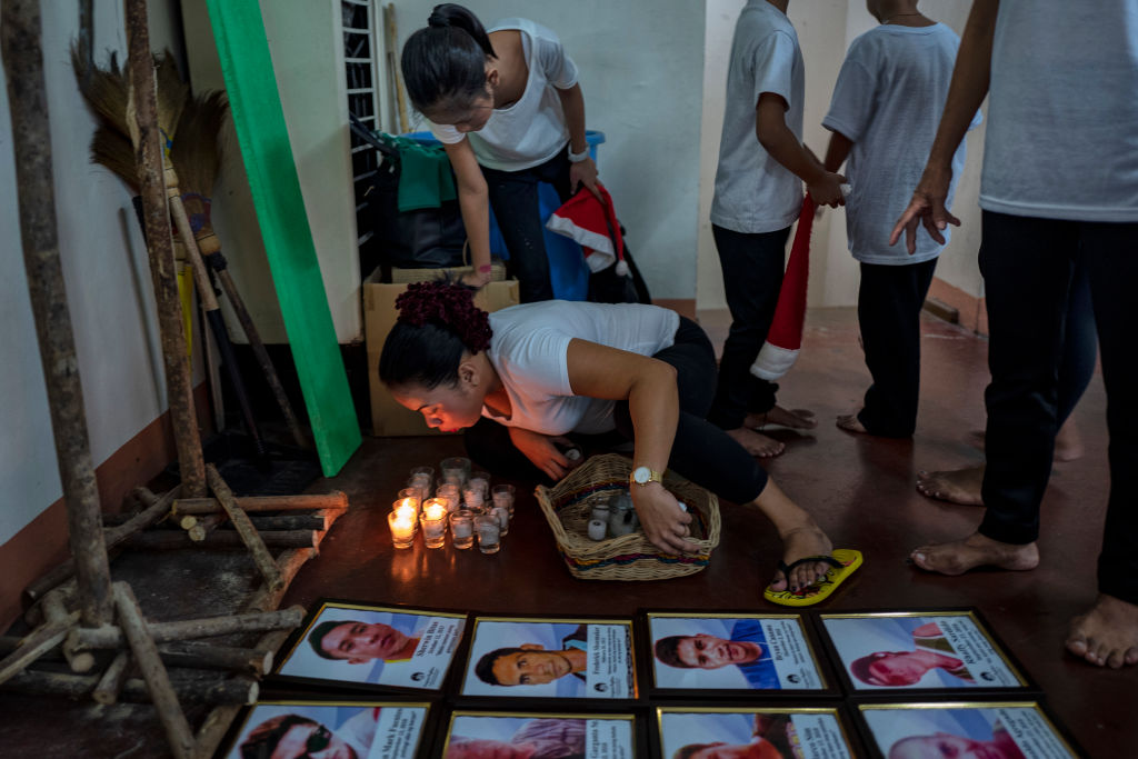 Relatives of victims killed in the drug war prepare backstage before performing in a play at a Catholic school on July 6, 2019 in Manila, Philippines. The play is part of a series of activities organized by the Catholic Church to help relatives of victims killed in the drug war cope with the trauma of losing their loved ones. (Ezra Acayan/Getty Images)