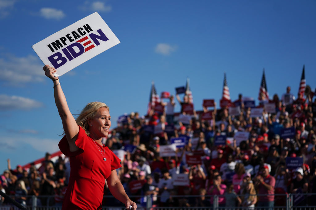 Rep. Marjorie Taylor Greene (R-GA) holds a sign that reads Impeach Biden at a rally featuring former US President Donald Trump in Perry, Georgia, on September 25, 2021. (Sean Rayford—Getty Images)