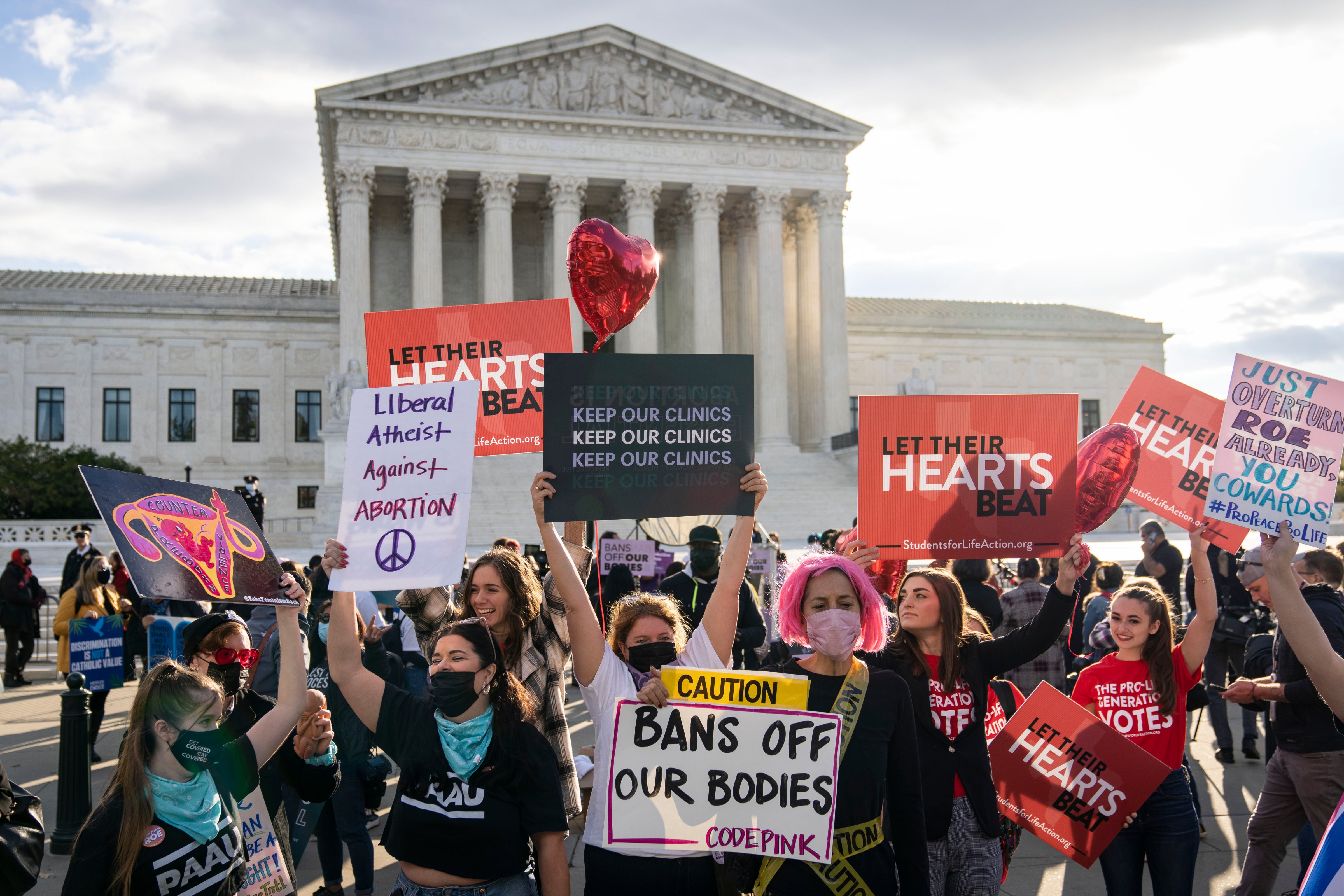 Pro-choice and anti-abortion demonstrators rally outside the U.S. Supreme Court on November 1. The Supreme Court is hearing arguments in a challenge to the controversial Texas abortion law which bans abortions after 6 weeks. (Photo by Drew Angerer—Getty Images)