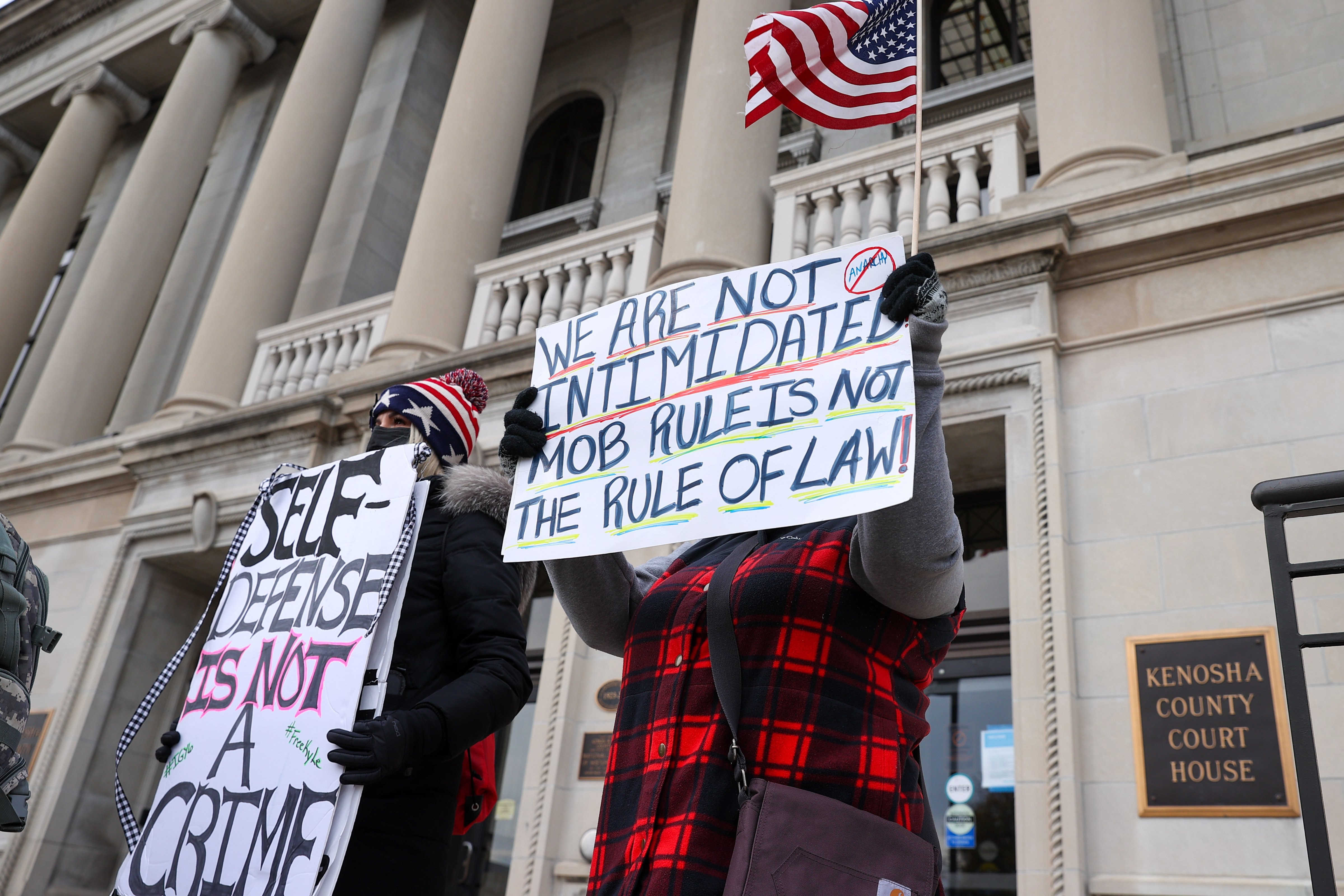 Supporters and opponents of Kyle Rittenhouse hold signs outside the courthouse in Kenosha, Wisc. on Nov. 16, 2021, as jurors deliberate. (Tayfun Coskup—Anadolu Agency/Getty Images)