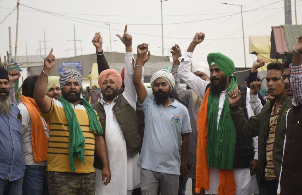 Farmers celebrate after Prime Minister Narendra Modi announced the repeal of new farm laws, on Nov. 19, 2021, in Ghaziabad, Uttar Pradesh, India (Sakib Ali/Hindustan Times via Getty Images)