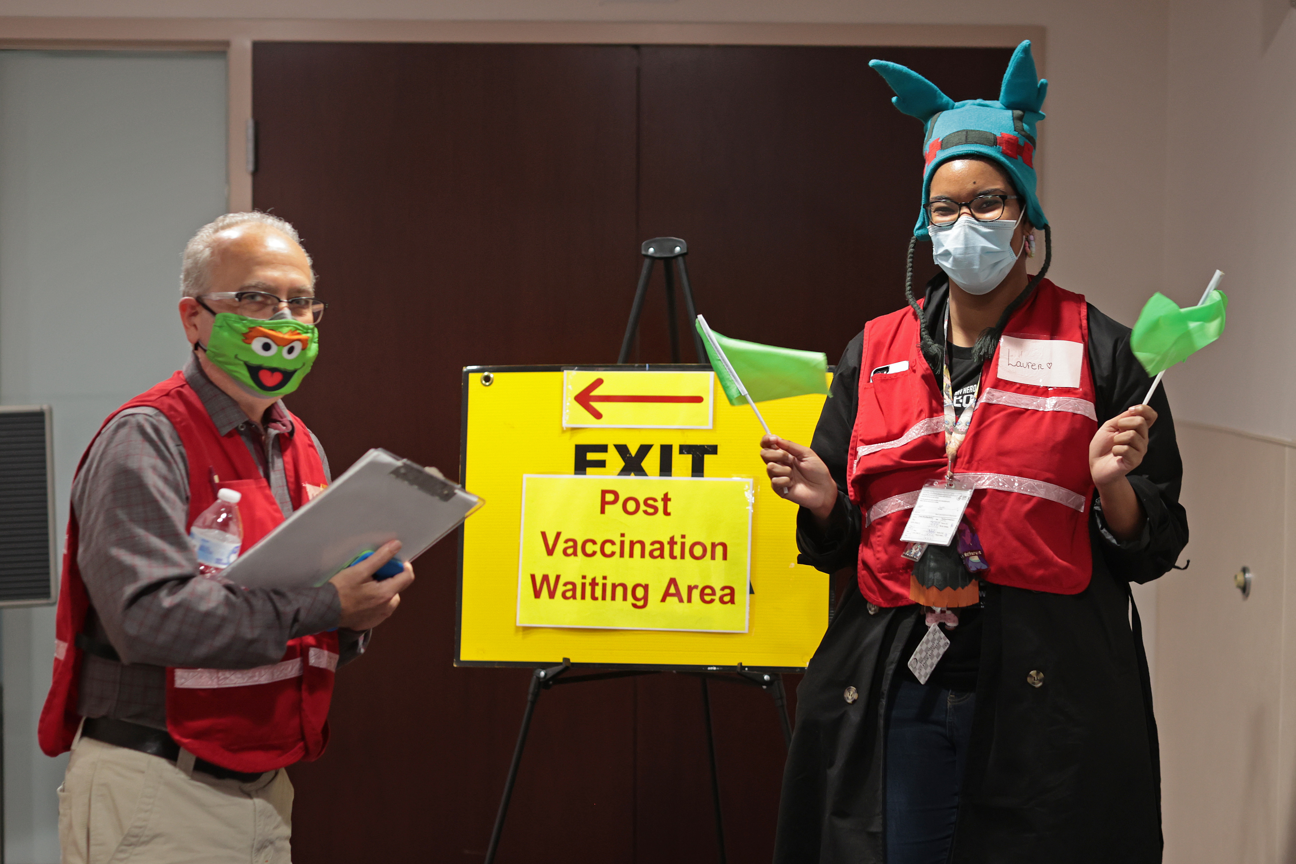 Ushers wear festive hats and masks to welcome children to the Fairfax County Government Center to receive COVID-19 vaccines on Nov. 4, 2021 in Annandale, Virginia. (Chip Somodevilla—Getty Images)