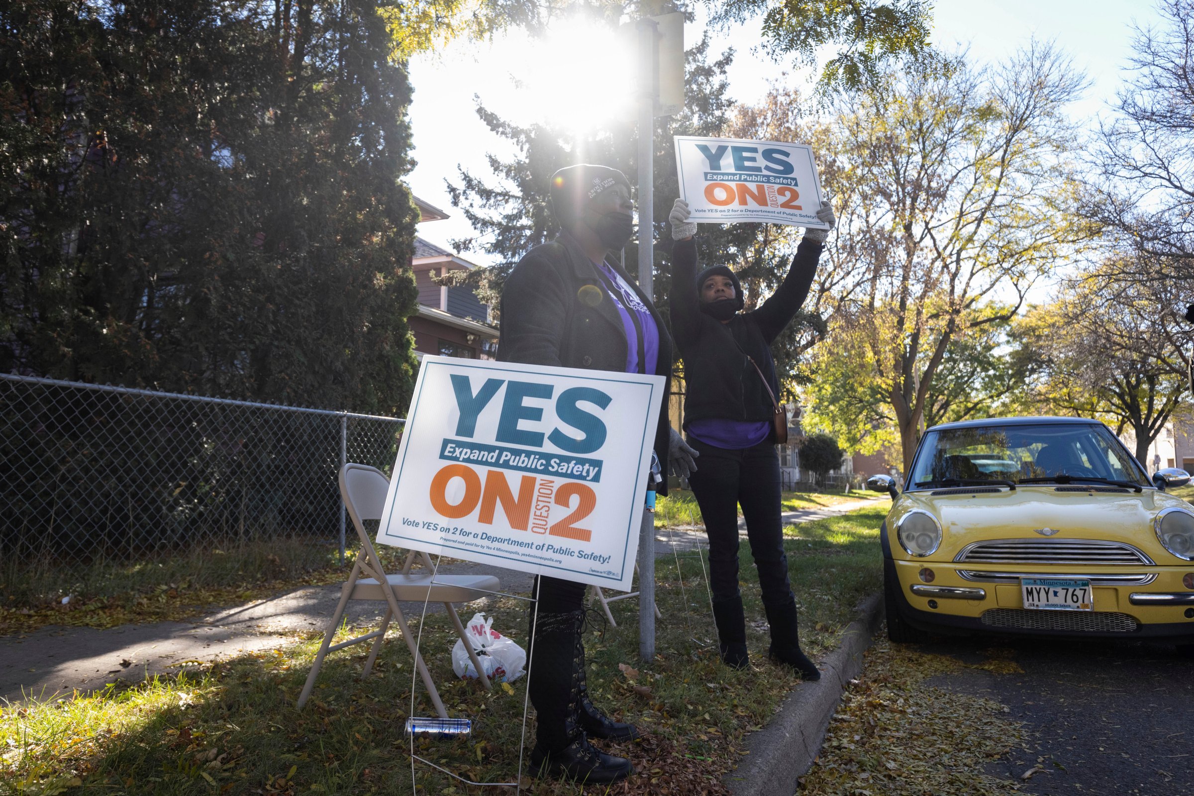 Volunteers urge community members to vote yes on ballot question two outside of a polling place on Tuesday, Nov. 2, 2021 in Minneapolis.