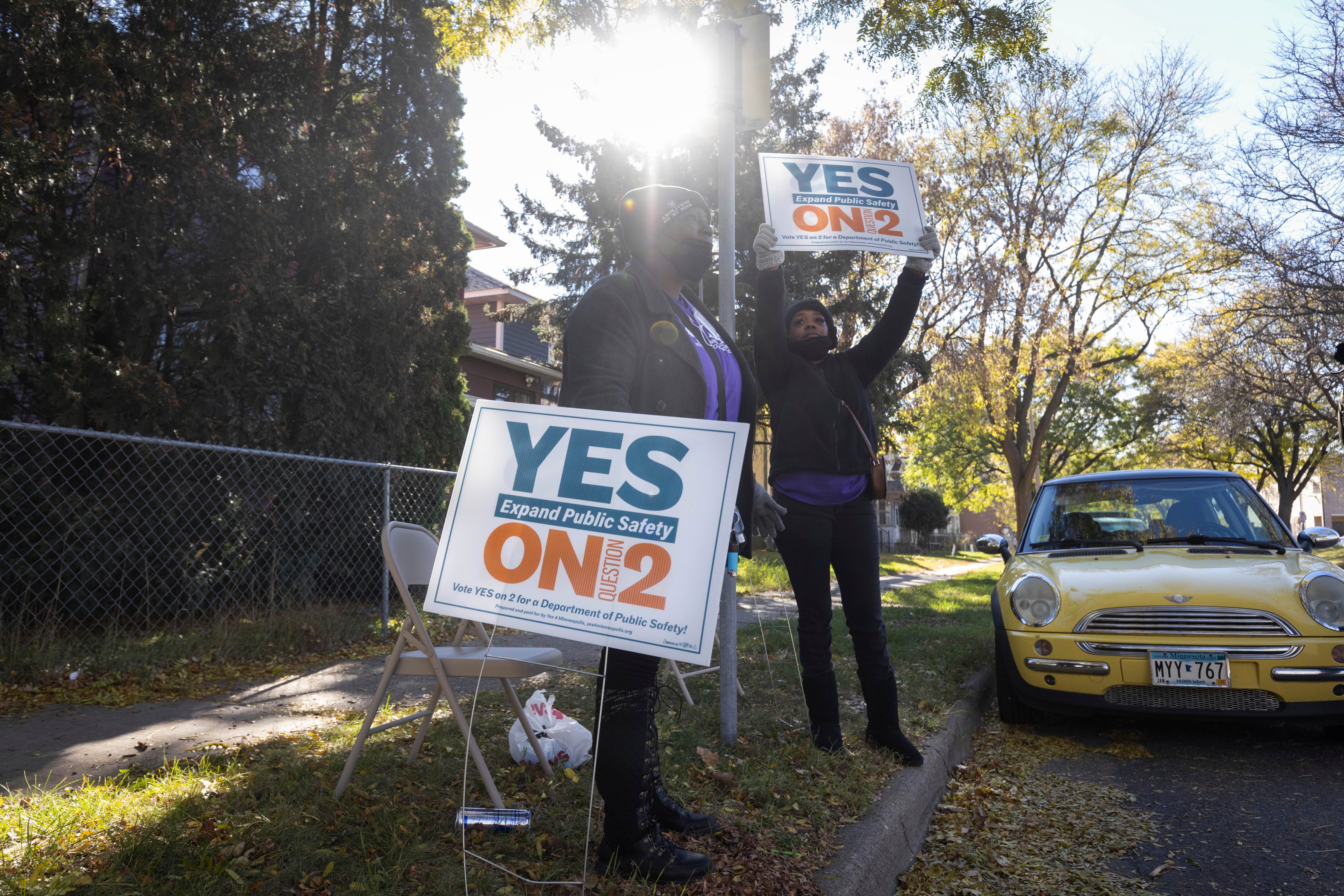 Volunteers urge community members to vote yes on ballot question two outside of a polling place on Tuesday, Nov. 2, 2021 in Minneapolis. Despite the disappointment from activists and community leaders on the results of the vote, they are now looking forward to the next steps in addressing public safety issues in the city. (Christian Monterrosa—The AP)