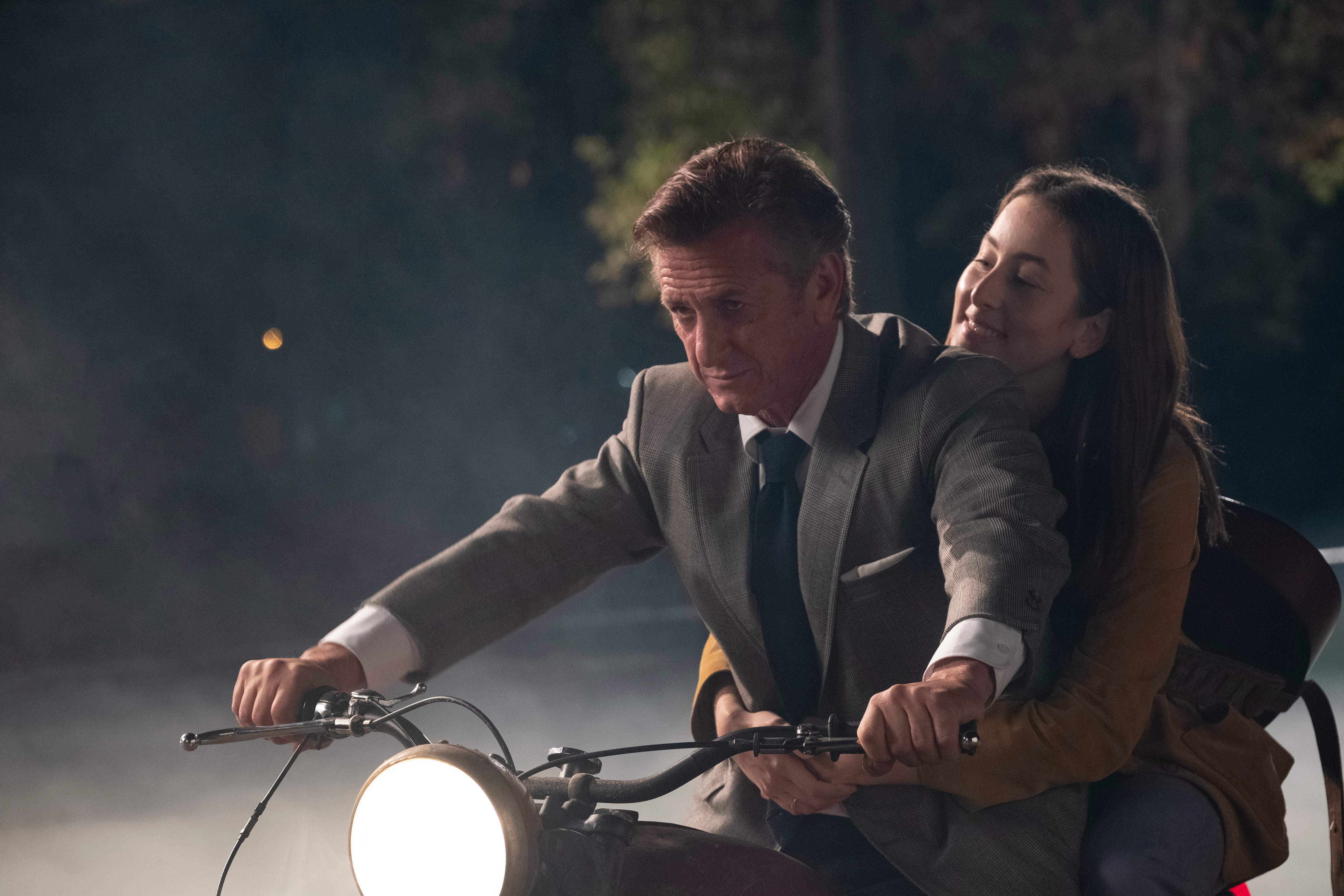 Haim (right) on the back of a motorcycle driven by Sean Penn (Melinda Sue Gordon—© 2021 Metro-Goldwyn-Mayer Pictures Inc. All Rights Reserved.)