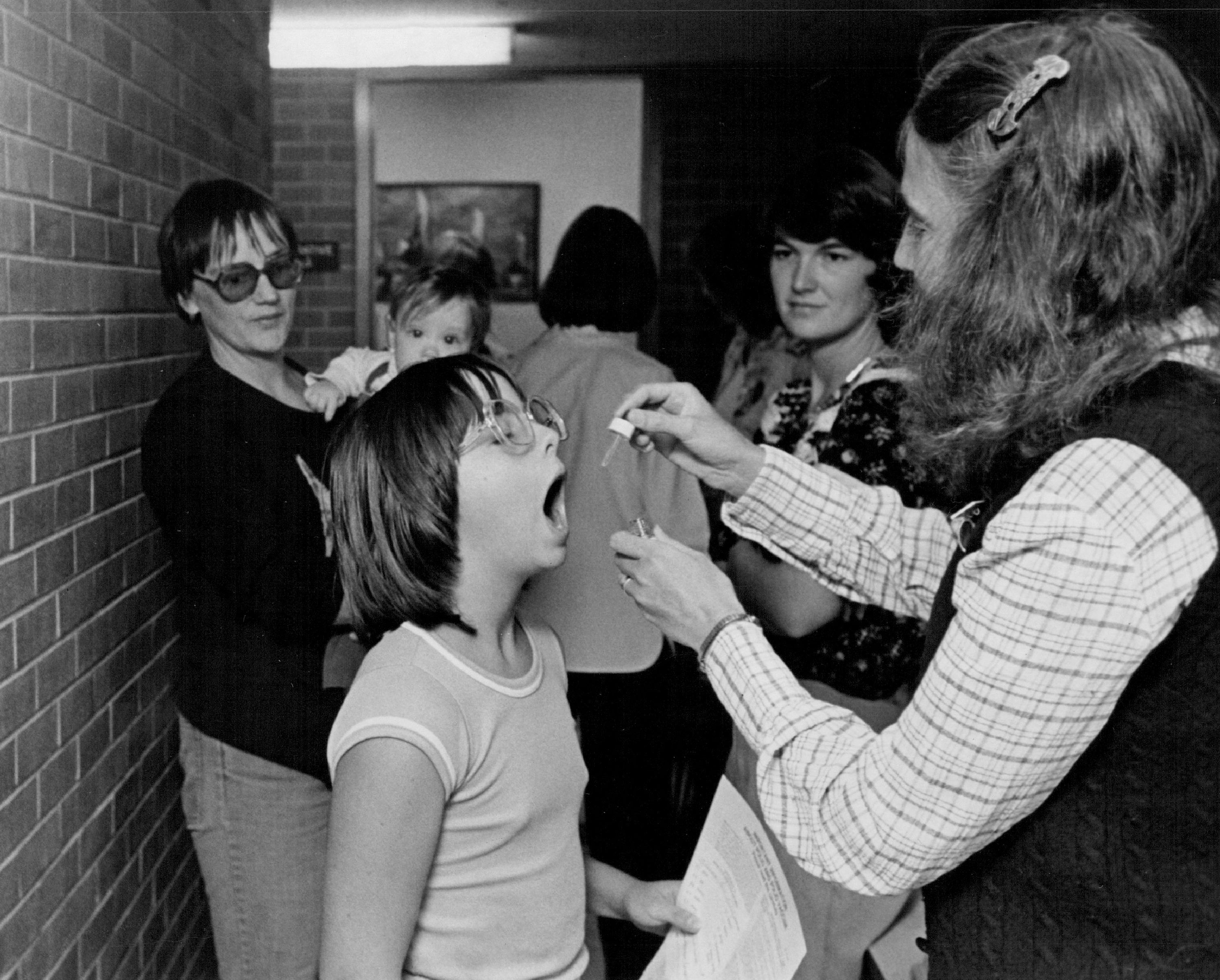 Lori Kelly, a public-health nurse, administers polio vaccine on Sept. 13,1979 to Kama Rotoli, 10, who was one of more than 1,500 school children in Jefferson Country who didn't receive immunization by a deadline. The shots were required by the state Immunization law and were necessary for entrance into public school. (Ed Maker/The Denver Post via Getty Images)